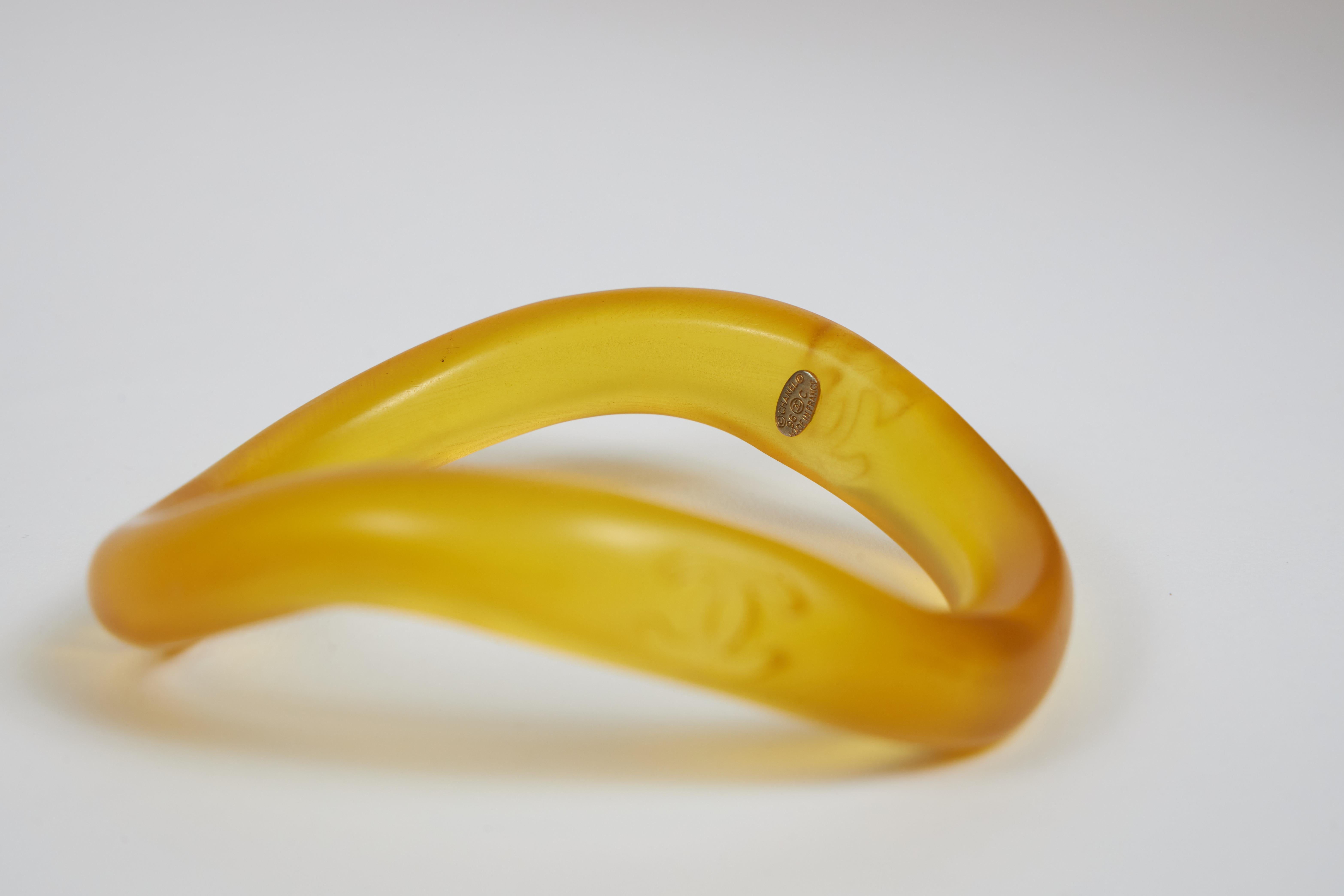 Chanel yellow resin irregular shape bangle bracelet. Cruise 96 collection. Comes with original pouch.