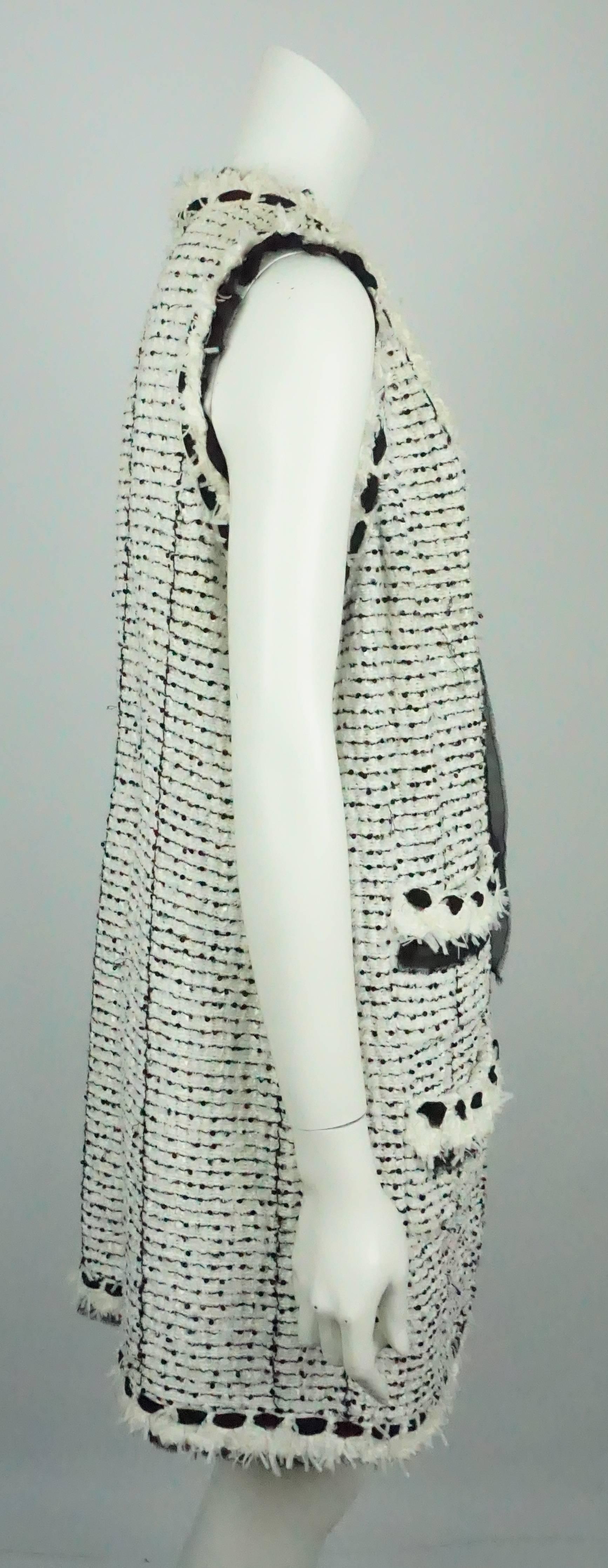 Chanel Ivory and Black Silk/Cotton Knit Lesage  Long Vest/ Duster - 48 - 05P This classic yet unique Chanel piece is made of ivory and black lesage fabric, it has chiffon ribbon trimming as well as the tie closures in the front, slight black sequin