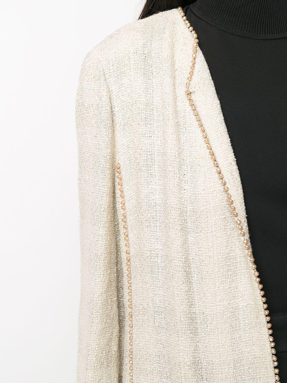 Chanel ivory mix wool beaded-trim jacket featuring a round neck, beads edges, hook and eye fastening, two front patch pockets. 
Estimated size: 40fr/US8/UK12
In excellent vintage condition. Made in France.
Composition: Coton 43%, Viscose 42%, Laine