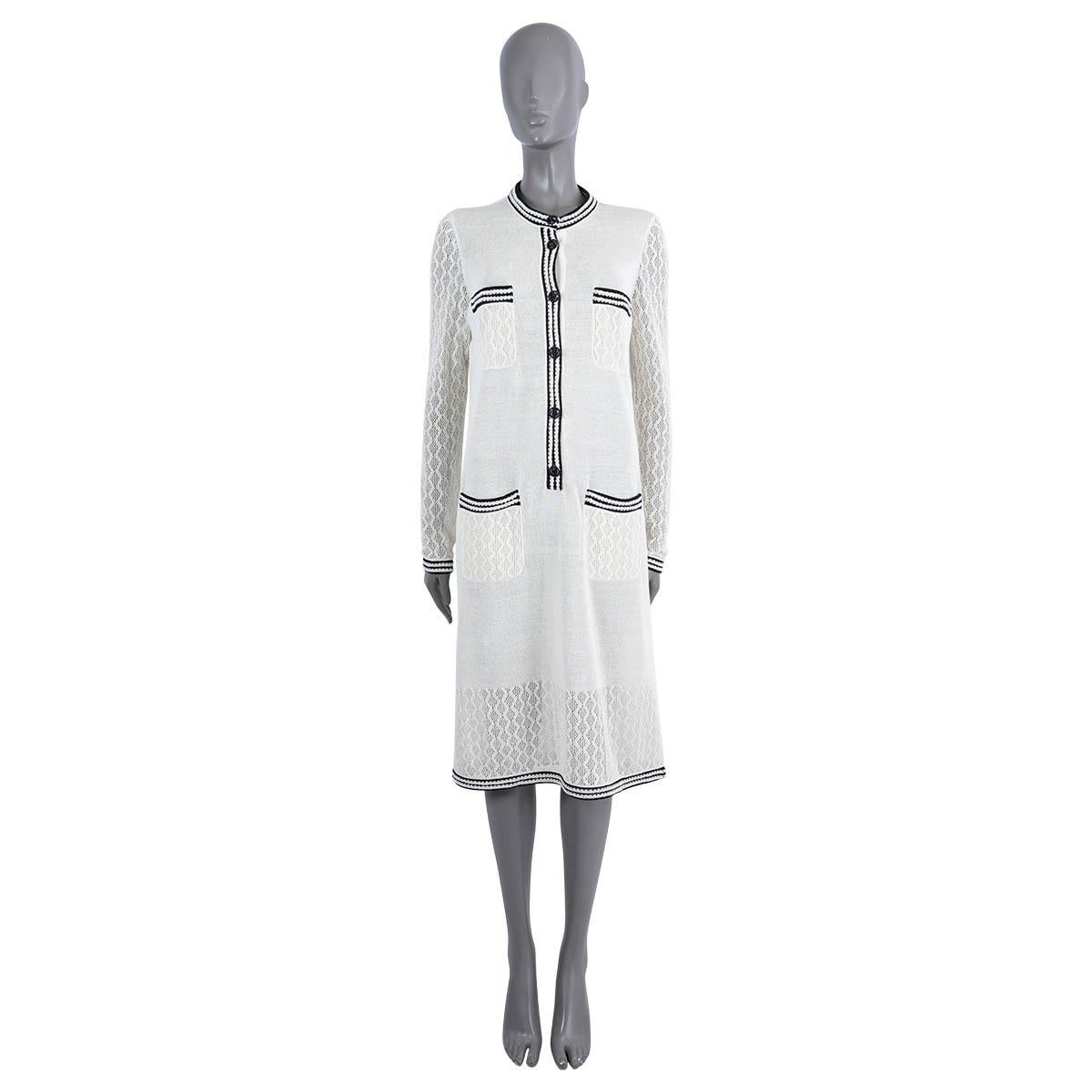 100% authentic Chanel semi-sheer knit dress in ivory silk (87%) and polyester (13%). Features a round neck, crochet sleeves, hem and four patch pockets on the front. Black and white striped viscose trim. Opens with black CC buttons on the front.