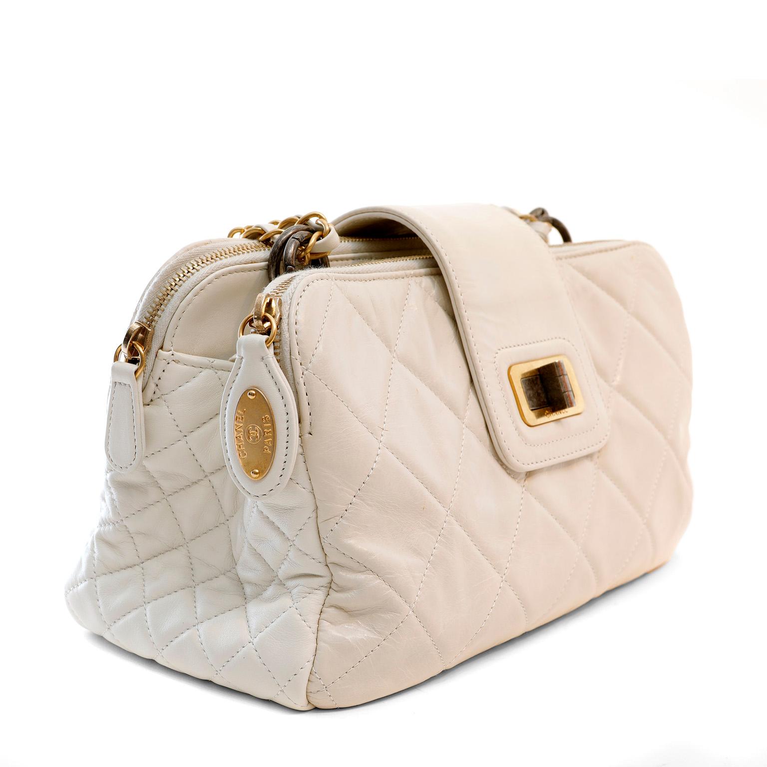 This authentic Chanel Ivory Calfskin Reissue Tote Bag is in excellent plus condition.  Neutral ivory calfskin is quilted in signature Chanel diamond pattern.  Double zippered compartments are joined together with a two-tone Mademoiselle twist lock