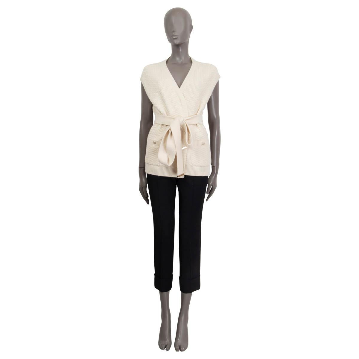 100% authentic Chanel Pre-Fall 2018 belted sleeveless knit cardigan in off-white cashmere (100%). Features two shut sewn 'CC' buttoned slit pockets on the front. Unlined. Has been worn and is in excellent condition. Matching pants available in