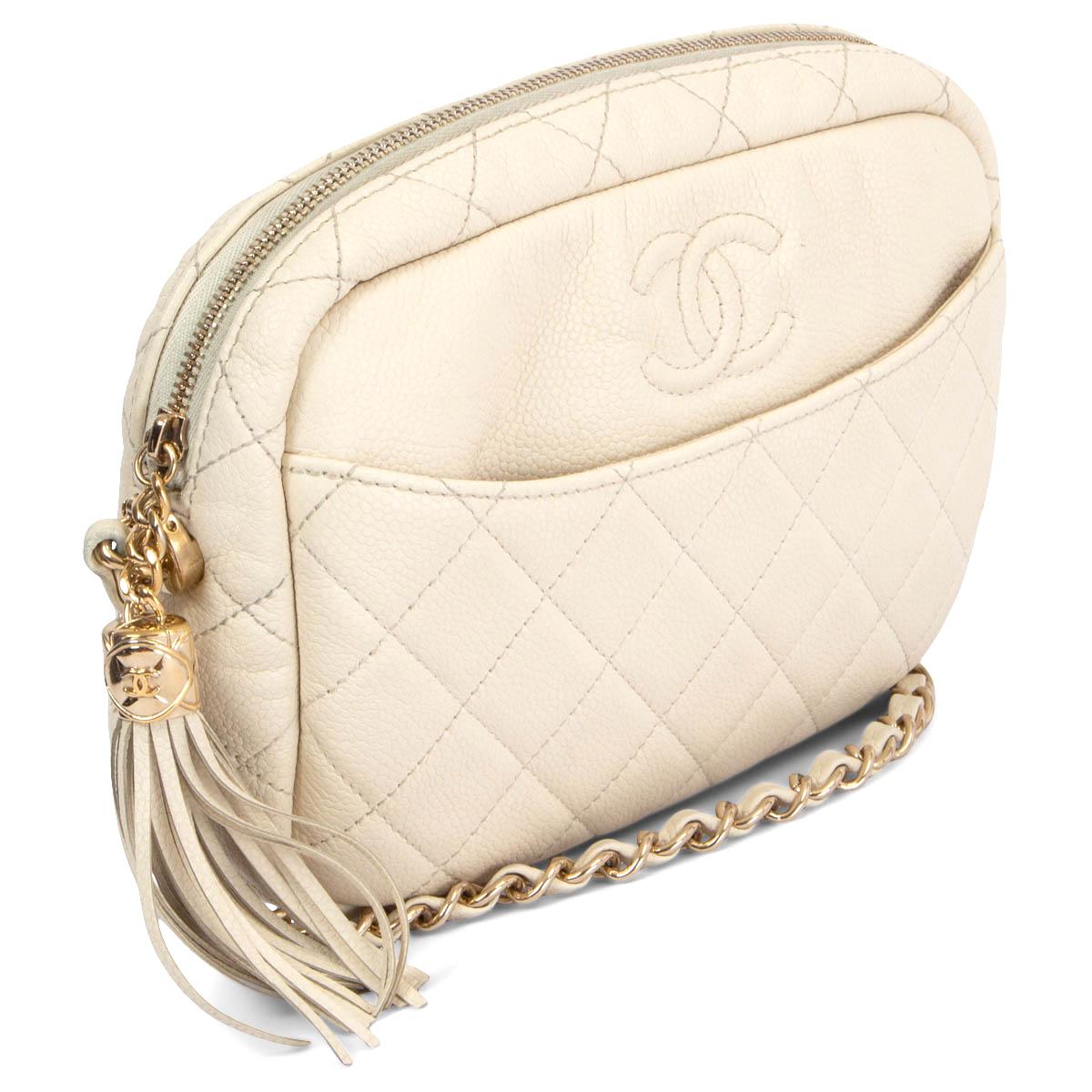 100% authentic Chanel Coco Tassel Camera shoulder bag in quilted ivory Caviar leather and light gold-tone hardware with one open front pocket. Opens with a tassel zipper on top and is lined in pale beige grosgrain fabric with one zipper pocket