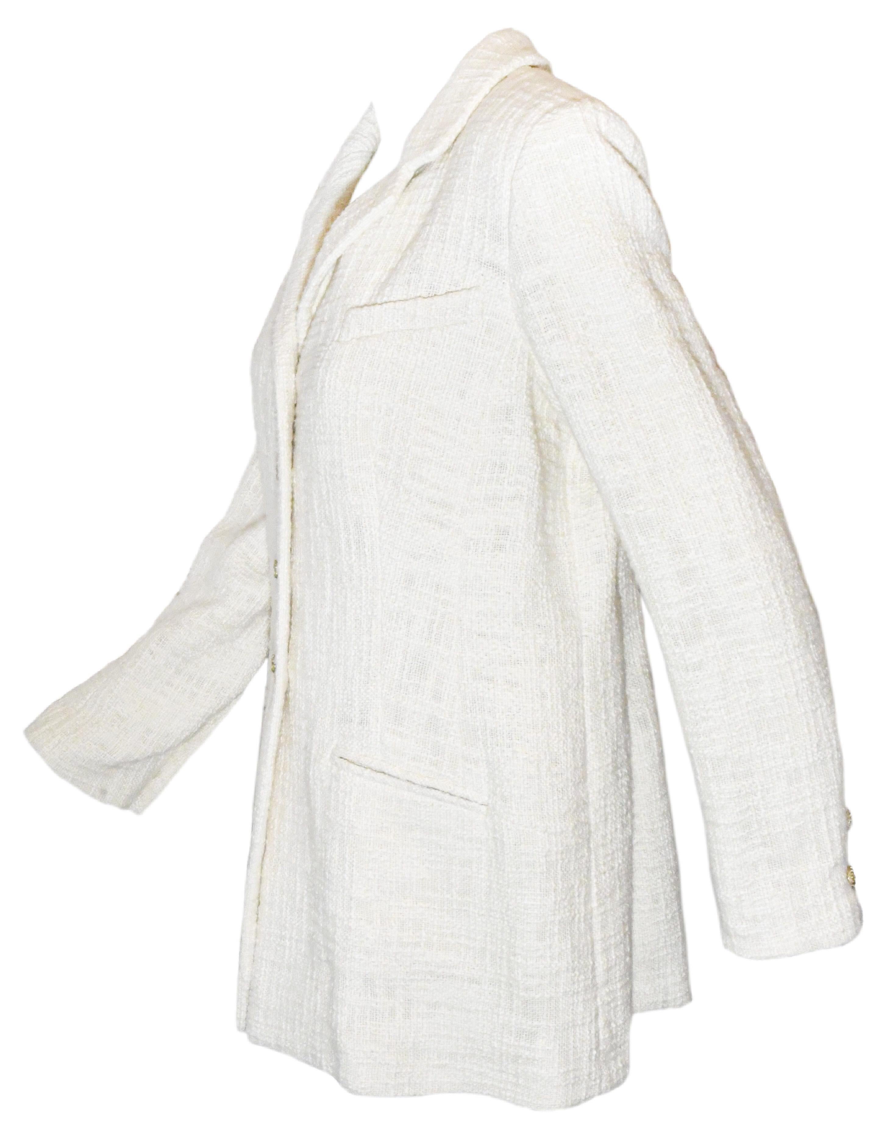 Chanel Ivory cotton tweed jacket includes, at front, for closure 4 Camellia Gripoix gold tone buttons.  This notch collar, single breasted jacket incorporates 2 faux side slit pockets and one faux chest pocket.  It is lined in ivory silk Camellia