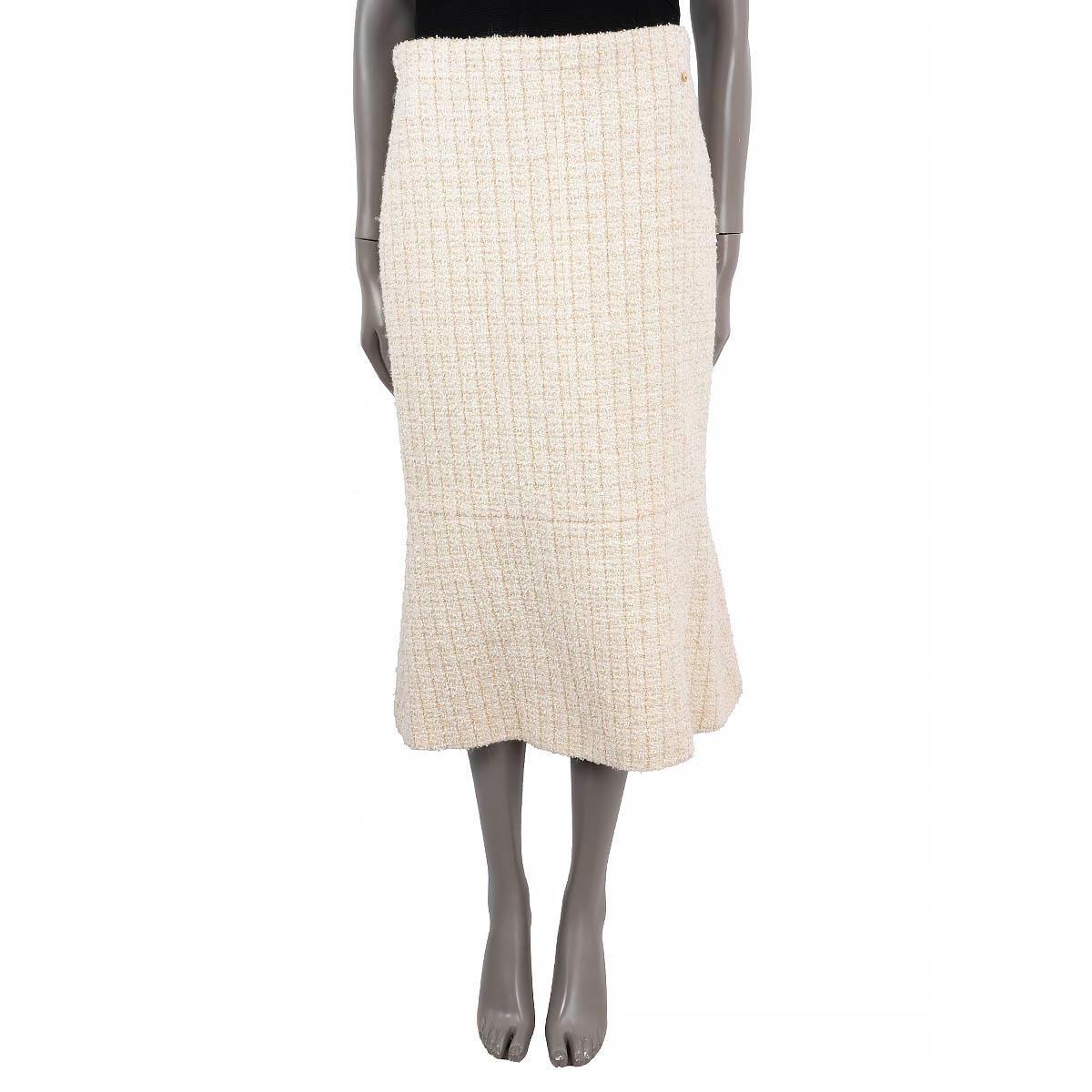 100% authentic Chanel Cosmopolite tweed midi skirt in ivory wool (33%), polyamide (31%), silk (25%), rayon (5%), mohair (3%) and polyester (3%). The design features a slightly flared bottom part, a concealed zipper and slit on the back. Lined in