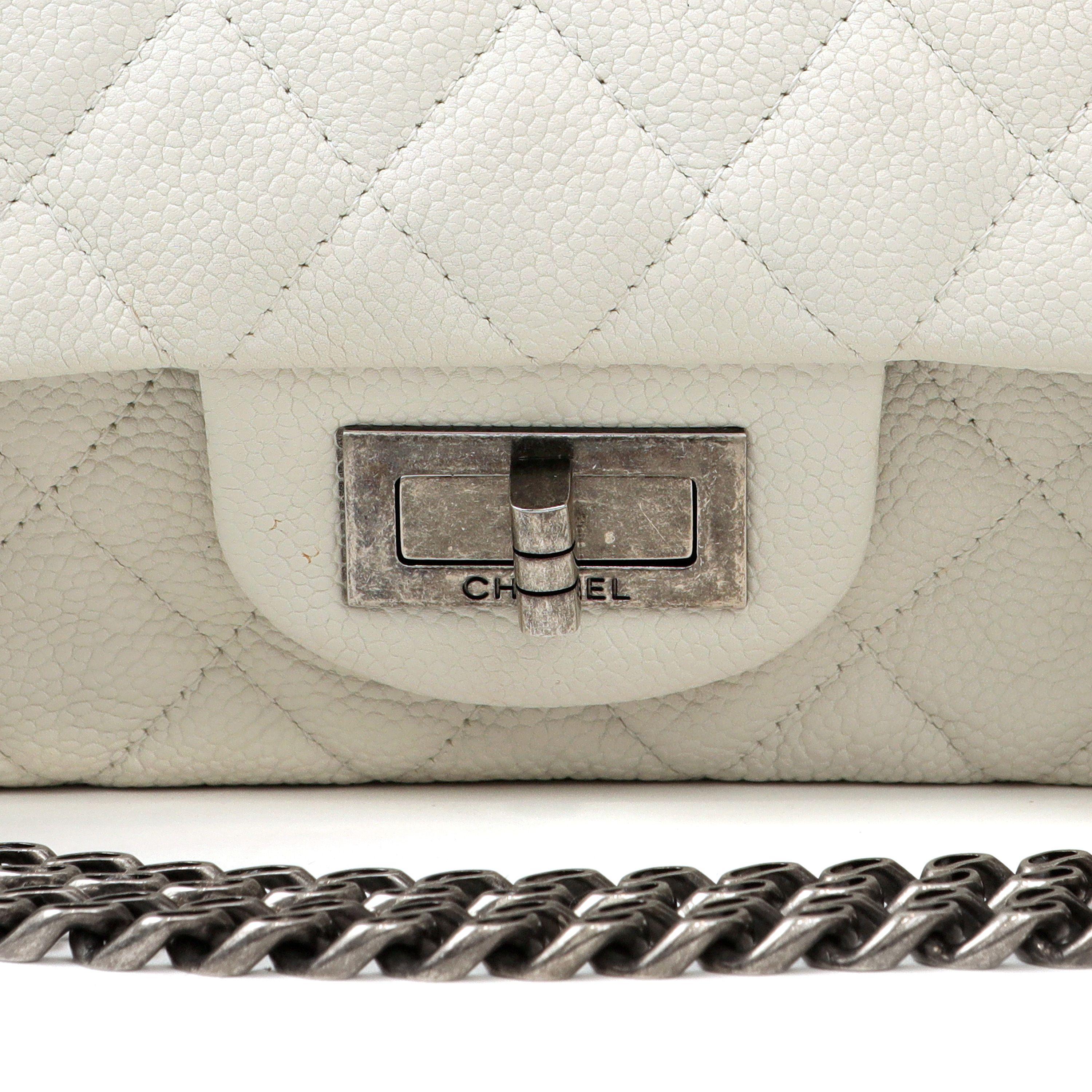 This authentic Chanel Ivory Caviar Medium 2.55 Reissue is in excellent condition.  Textured and quilted caviar leather with ruthenium mademoiselle twist lock clasp.  Unique curb chain style strap may be carried single or double.  Dust bag