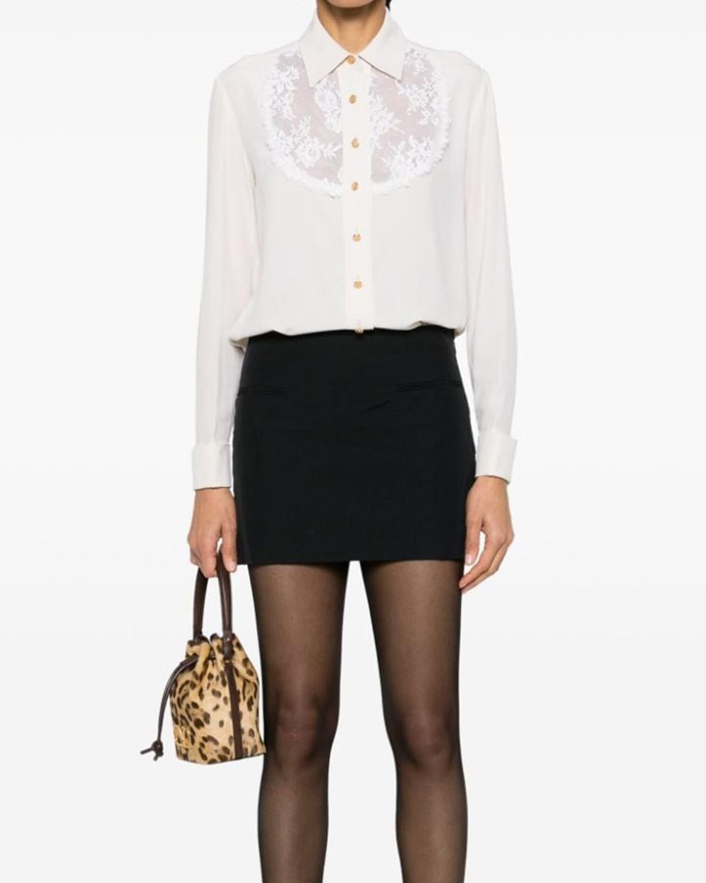 Chanel ivory lace-detail silk shirt featuring a classic collar, lace detailing, gold-tone front button fastening, long sleeves, buttoned cuffs,straight hem.
Composition: 100% silk
Circa: 1990s
Made in France. 
In excellent vintage condition.