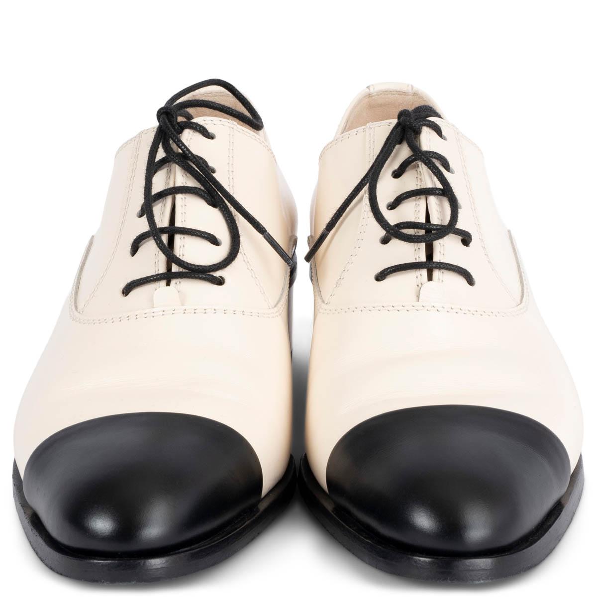 100% authentic Chanel 2022 lace-up block-heel derbies in ivory smooth leather featuring classic black cap-toe. Have been worn once and show some soft dark lines on the heel and on the side of the right shoe. Overall in excellent condition.
