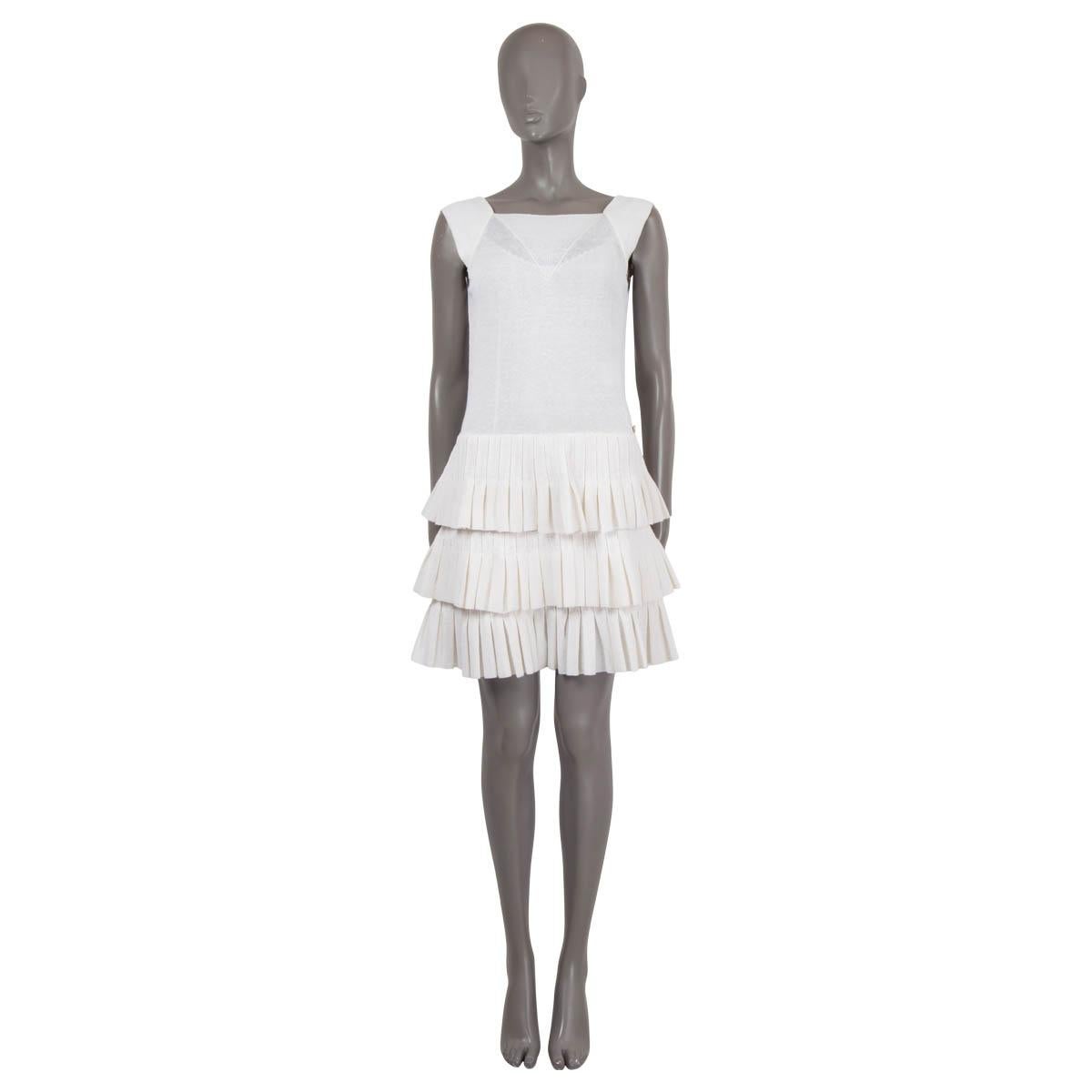 100% authentic Chanel sleeveless knit dress in ivory linen (80%) and nylon (20%). Features a semi-sheer top and tiered, pleated skirt. Comes with a slip dress in ivory silk (14% elastane). Has been worn and is in excellent condition.

2014