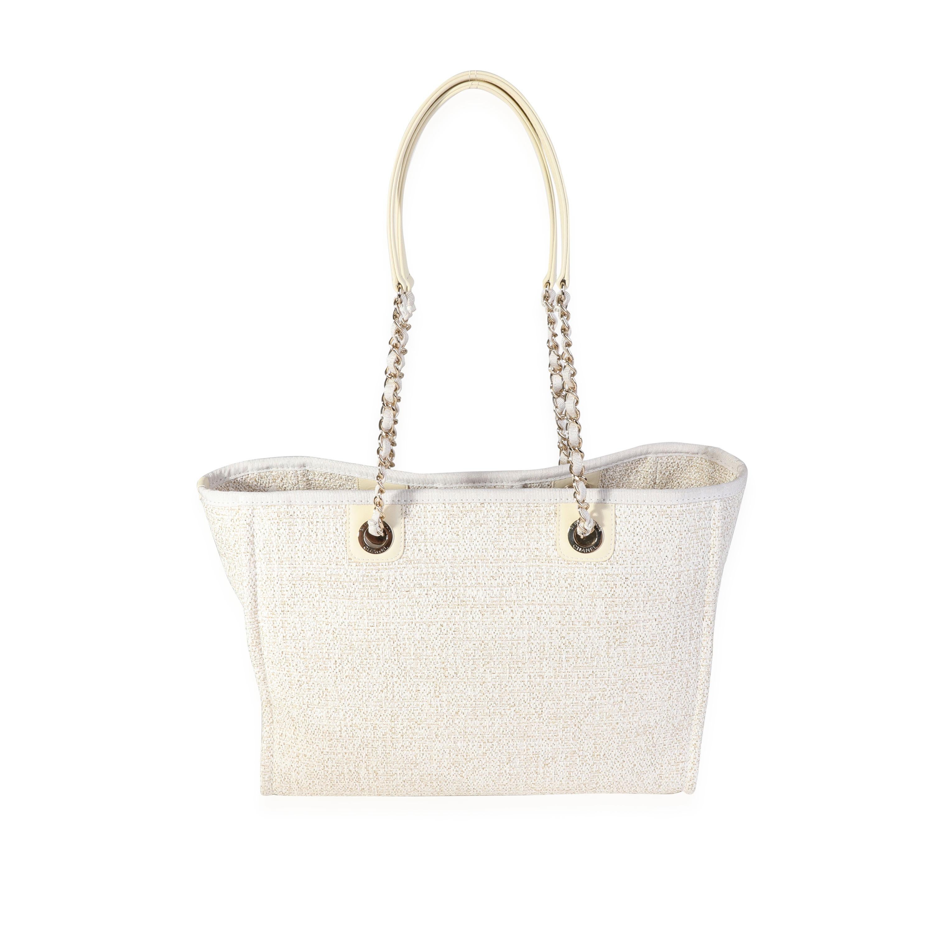 Listing Title: Chanel Ivory Metallic Tweed Small Deauville Shopping Tote
SKU: 118300
Condition: Pre-owned (3000)
Handbag Condition: Excellent
Condition Comments: Excellent Condition. Plastic on some hardware. Discoloration on exterior topline. No