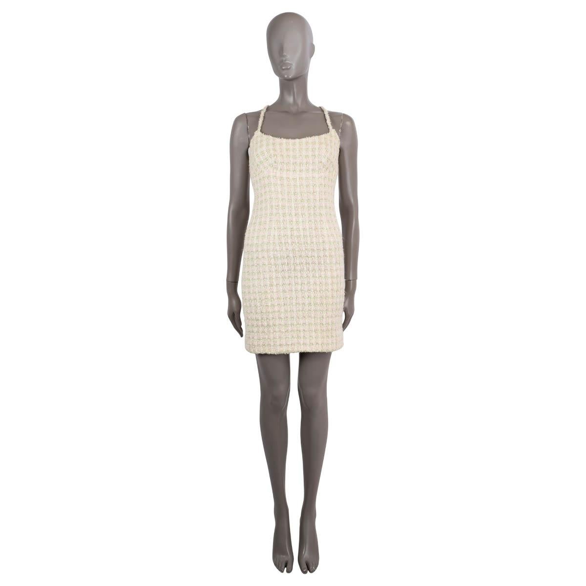 100% authentic Chanel tweed sheath dress in ivory, pale green and pink nylon (49%), acryllic (26%), wool (14%) and viscose (11%). Features a fitted silhouette, spaghetti straps that cross over in the back with two gold-plated logo buttons. Closes