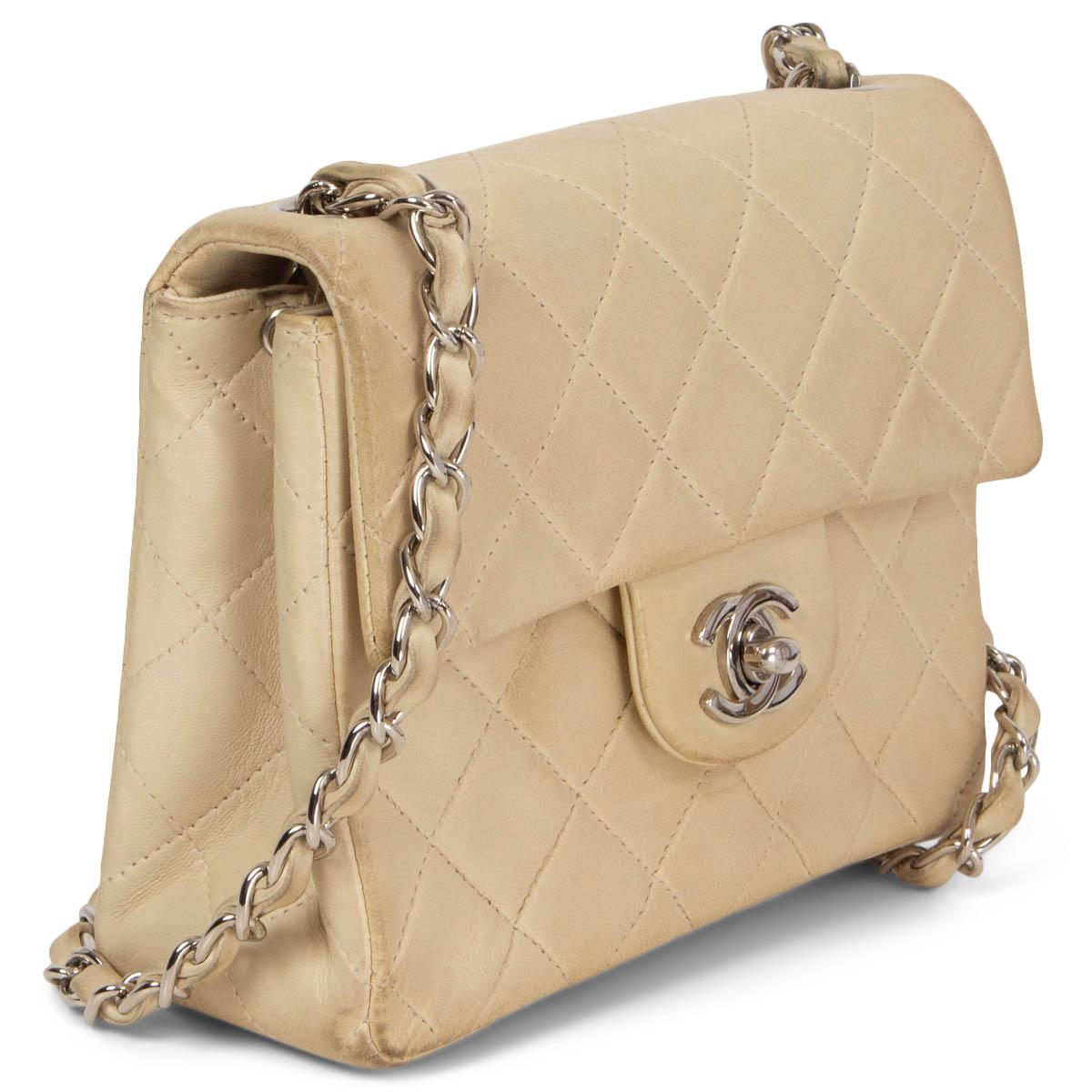 100% authentic Chanel Vintage Square Mini Flap bag in off-white quilted lambskin featuring silver-tone hardware. Opens with a CC turn-lock and is lined in off-white leather and grosgrain with one zip and open pocket against the back. Has been