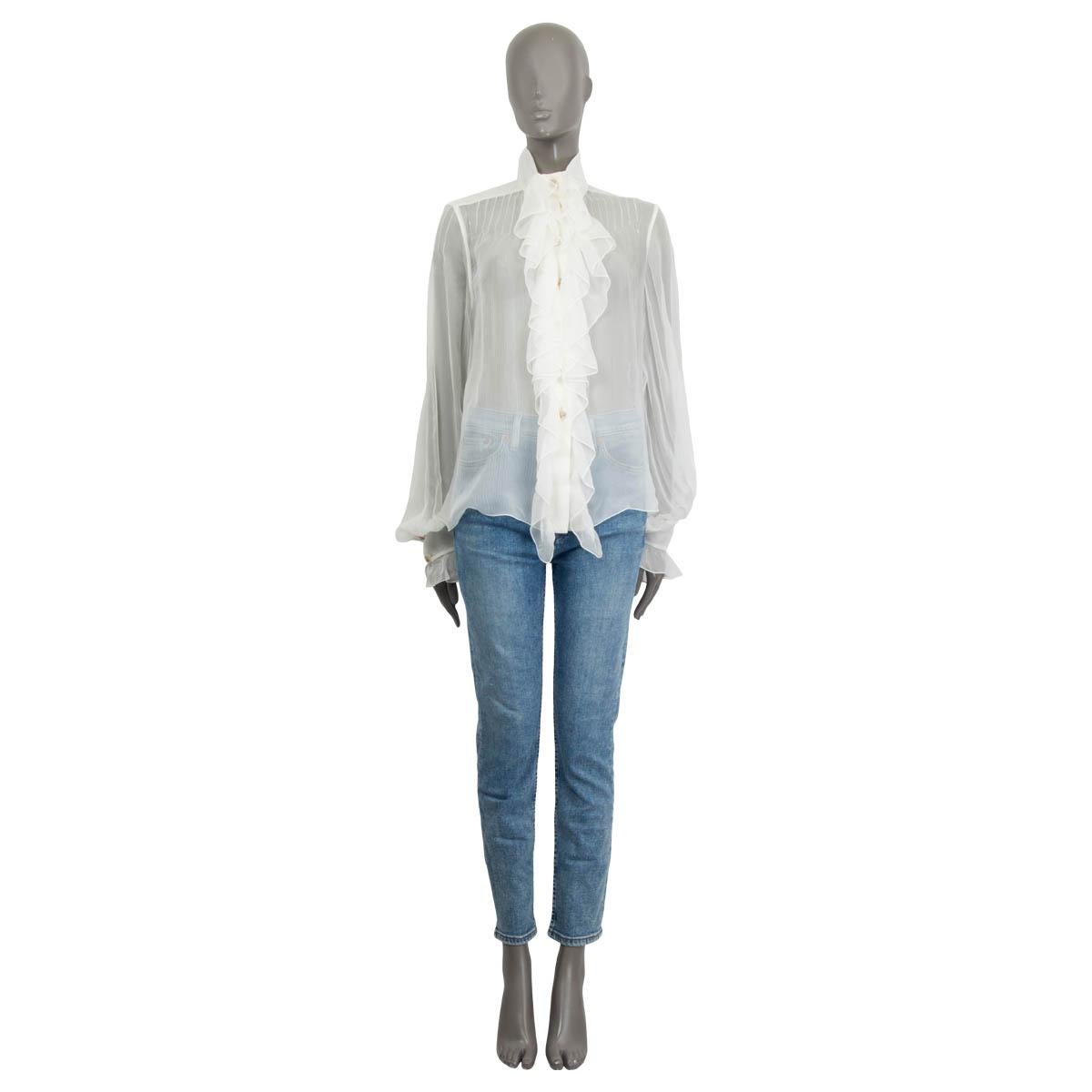 100% authentic Chanel 2019 sheer blouse in ivory silk (100%) with ruched detail at front that opens with seven lion head buttons in mother-of-pearl. Features a high collar and ruched cuffs that close with two buttons. Has been worn once and is in