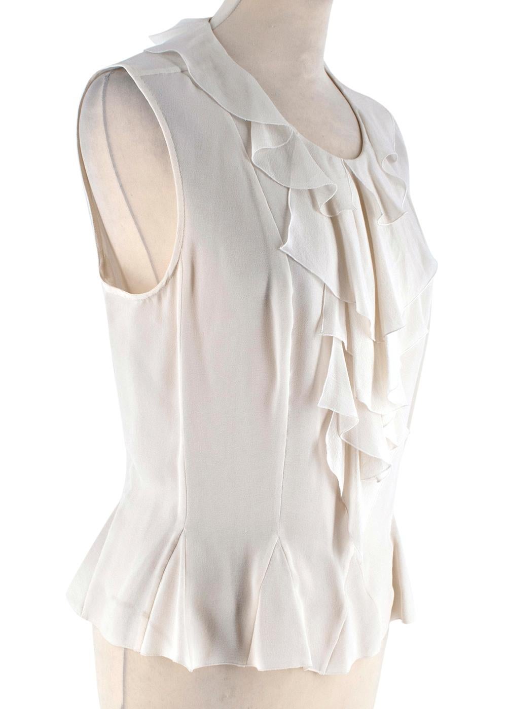 Chanel Ivory Silk Ruffled Sleeveless Blouse

-Made of super soft lightweight silk 
-Ruffled detail to the neck and front 
-Round neckline 
-Classic cut 
-Small triangular panels to the hem giving it a flared effect 
-Branded chanel pearl button