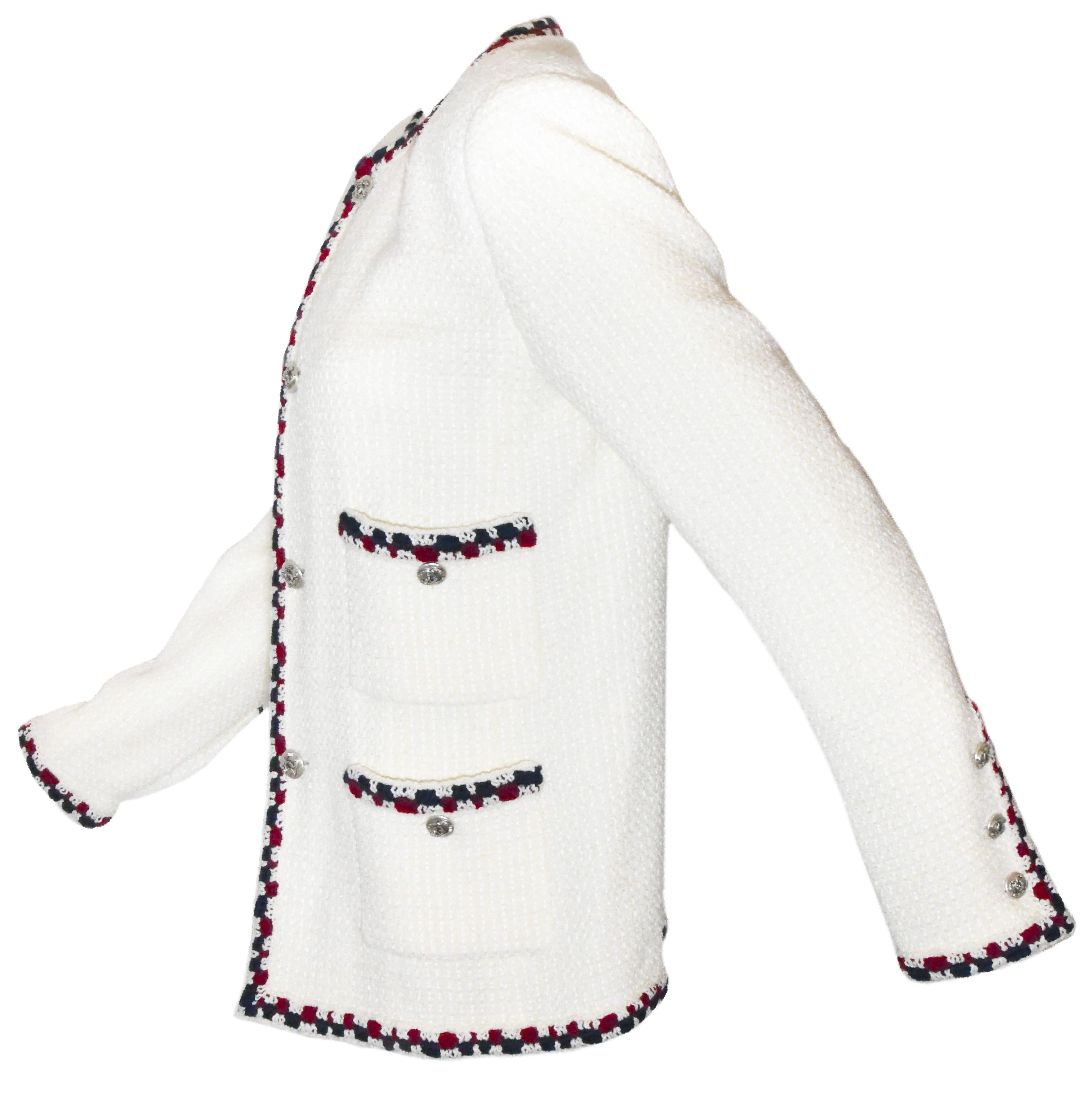 Chanel jacket features signature trim that has been crocheted with blue and red yarn on the 4 front patch pockets, the neckline, front and hem of jacket.  Crafted from exquisite ivory tweed with matching silk lining, jacket has classic Chanel