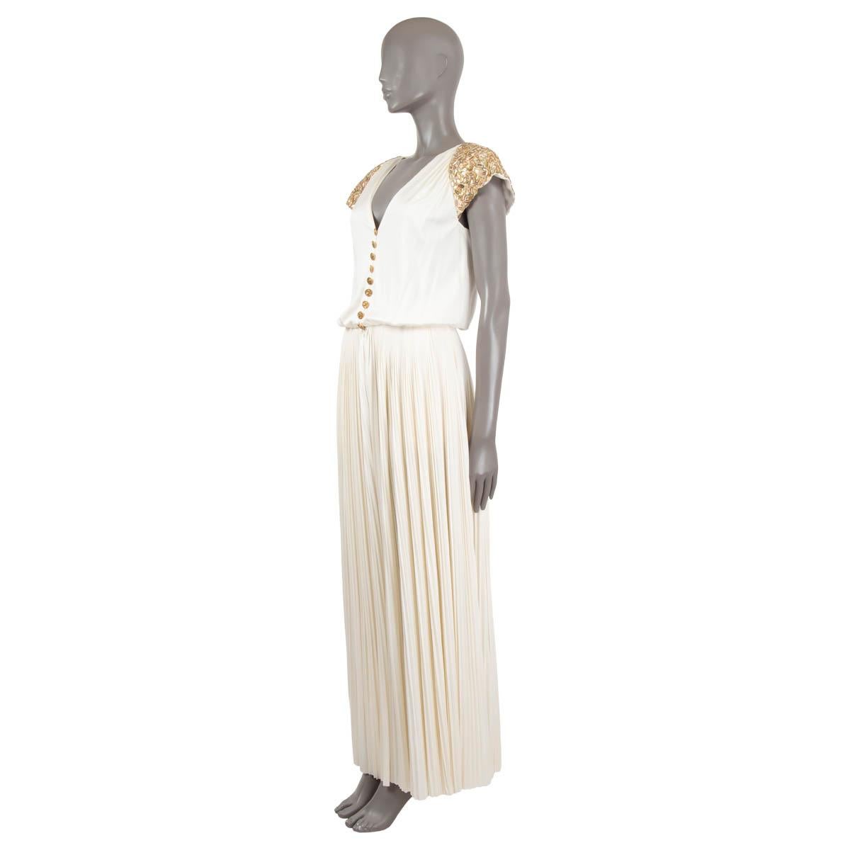 100% authentic Chanel beaded cap sleeve jumpsuit in ivory viscose (83%) and silk (17%) with wide pleated legs and nine embellished gold-tone metal buttons at front. Lined in silk (100%). Has been worn once and is in virtually new condition. 

2018