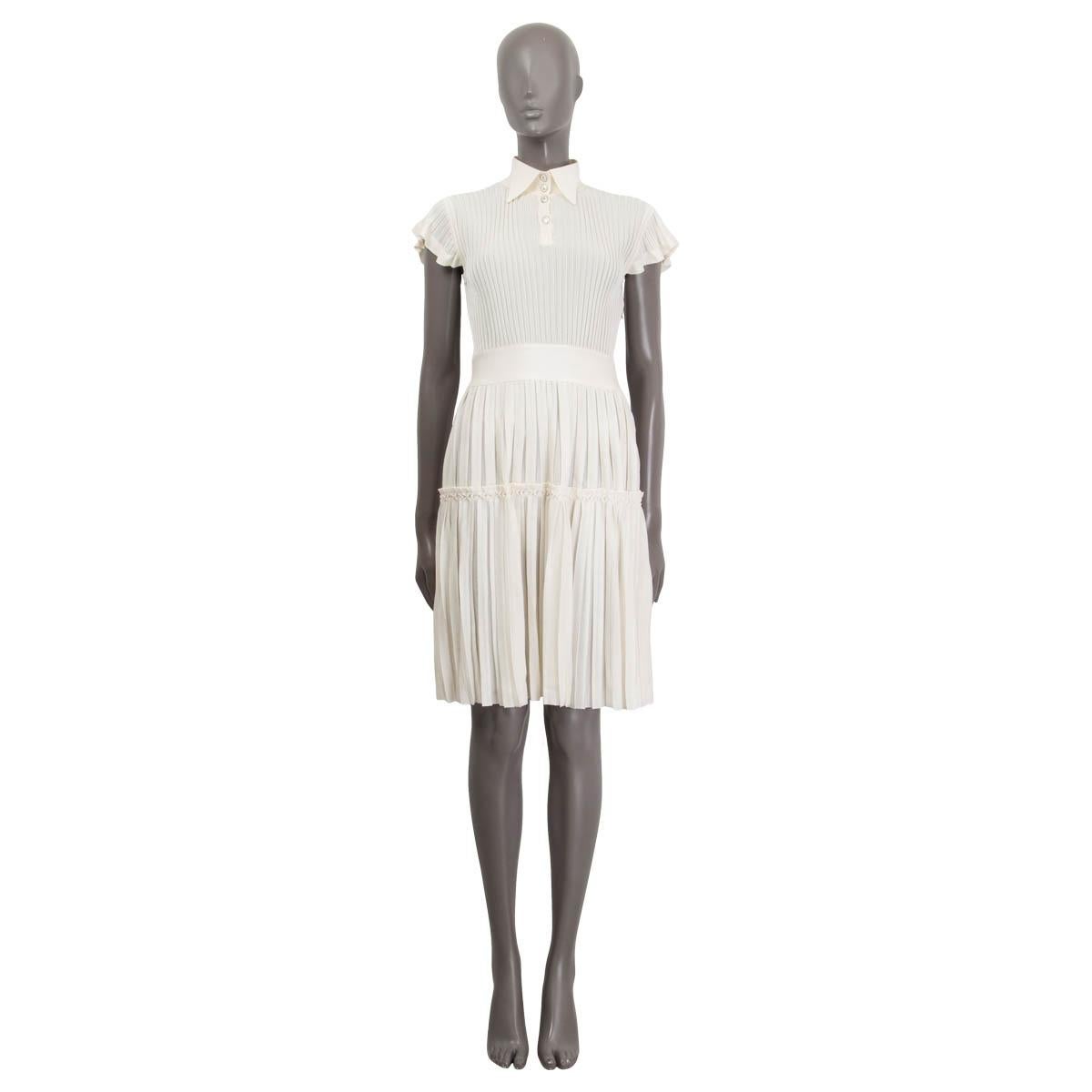 100% authentic Chanel 2018 Pleated Short Sleeve Knit Dress in ivory viscose (76%) and silk (24%) with a wingtip collar and 4 CC logo silver-tone front buttons. Dress has a ribbed top part nad pleated skirt part with a zipper on the side and a slip