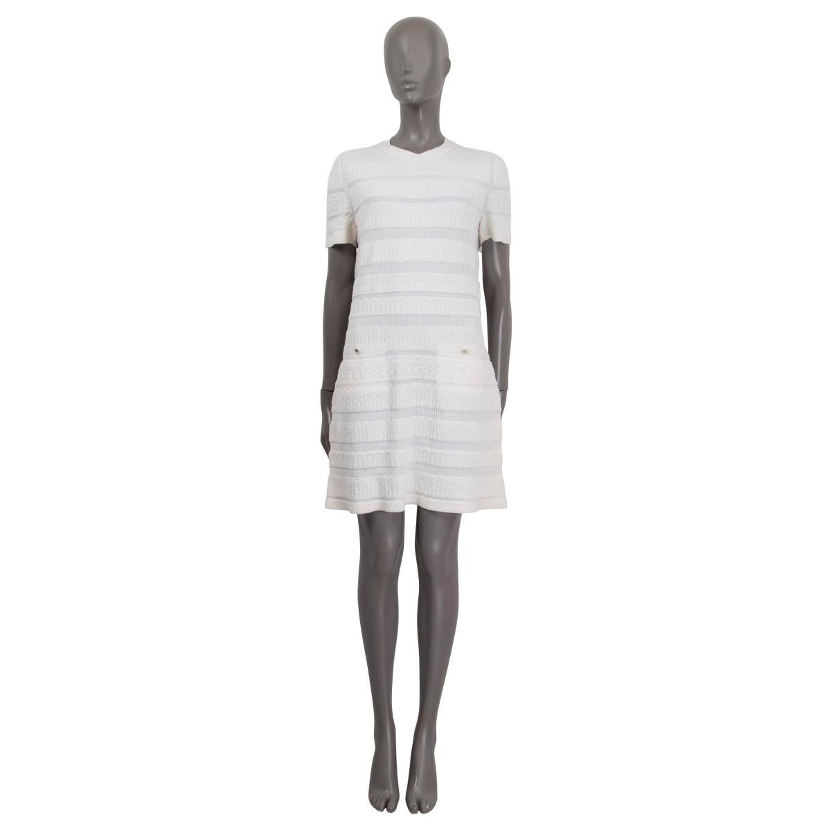 100% authentic Chanel 2019 short sleeve knit dress in ivory wool (96%) and polyamide (4%). Features two sewn shut 'CC' buttoned pockets on the front. Opens with five 'CC' buttons on the back. Unlined. Has been worn and is in excellent