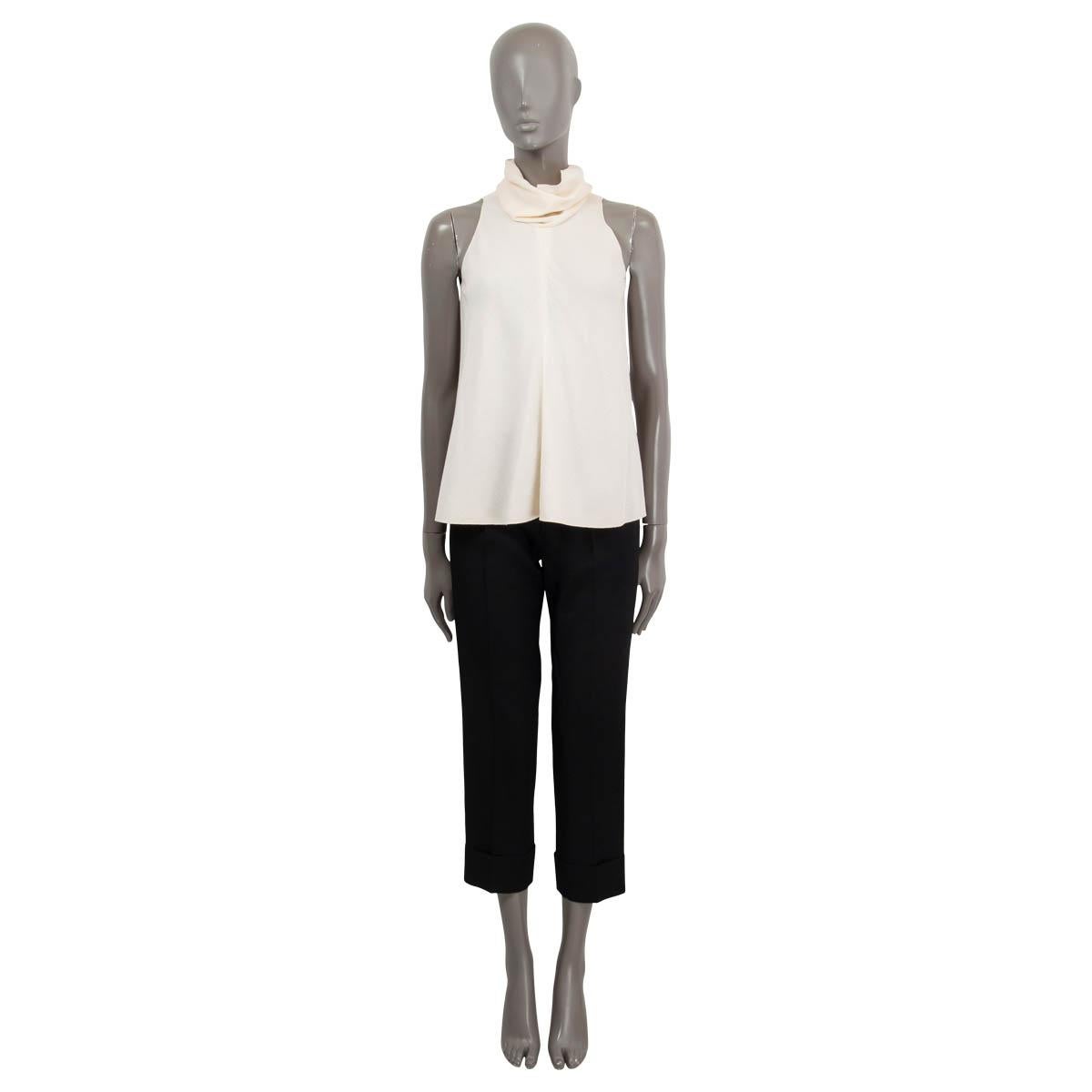 100% authentic Chanel sleeveless turtleneck top in ivory wool (100%). Closes on the back with concealed metal hooks. Unlined. Has been worn and is in excellent condition.

2007 Spring/Summer

Measurements
Model	Chanel07P
Tag Size	36
Size	XS
Bust
