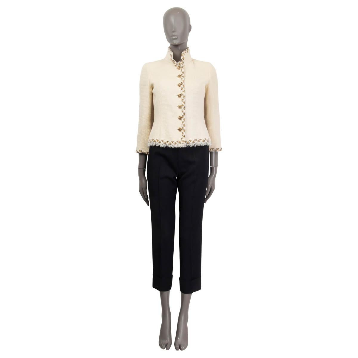 100% authentic Chanel 'Paris Byzance'  tweed blazer in ivory wool (95%) and nylon (5%). Metier's d'Art 2011 collection. Features Gripoix buttons, white fringes at the hemline and gold lurex embellishments around the collar, hemline, cuffs and the