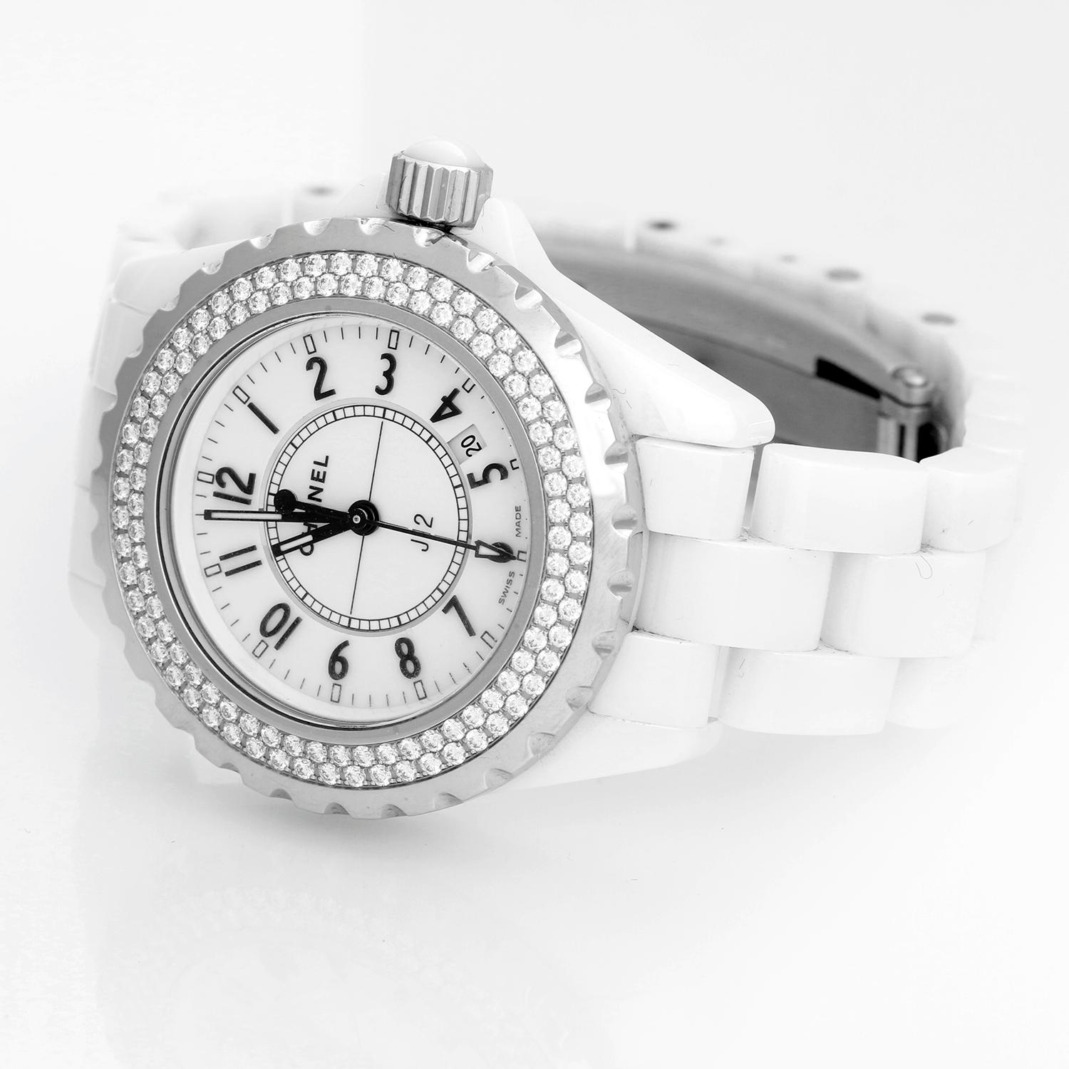 Chanel J12 White Ceramic  33mm  Diamond Watch H0967 - Quartz. White ceramic case with 2-row diamond bezel (33mm diameter). White dial with black Arabic numerals; date between 4 & 5 o'clock. White ceramic bracelet. Pre-owned with Chanel box and card.