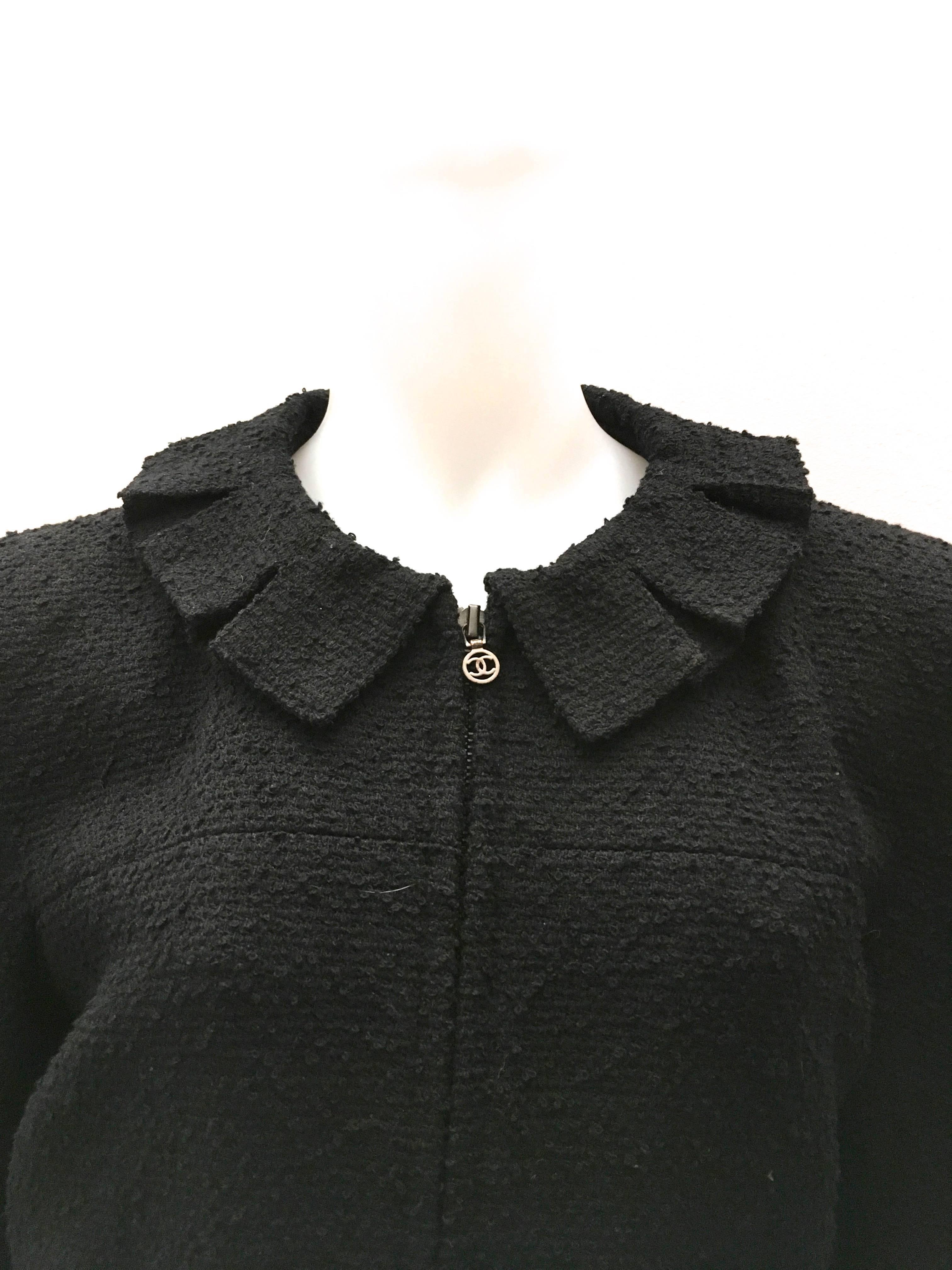Presented here is a magnificent Chanel black boucle jacket from the 1997 Fall Collection. The size listed on the tag is 42, but please pay close attention to the measurements, because my best guess is that it has been altered and is closer to a size