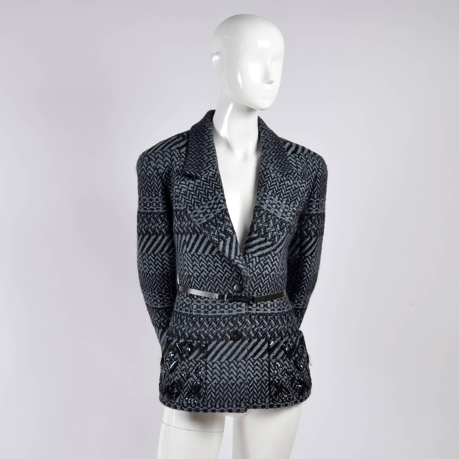 This is an absolutely gorgeous wool Chanel jacket with chevron, diagonal stripes and checked patterns alternating throughout. This jacket has a thin belt and is from the Autumn/Winter 2000 Chanel collection. 

This two button blazer has CC logo