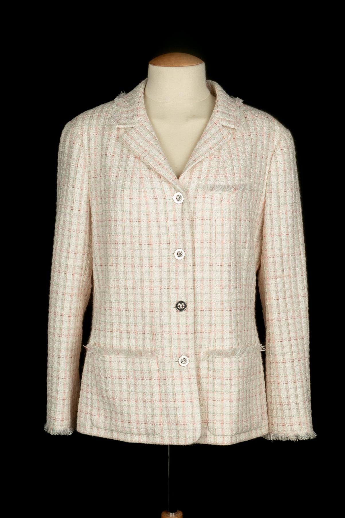 CHANEL - (Made in France) Blue, pink, and white tone tweed jacket with silvery metal buttons decorated with rhinestoned cc logos. Size 46FR indicated. 2004 Cruise Collection under the direction of  Karl Lagerfeld.

Condition:
Very good