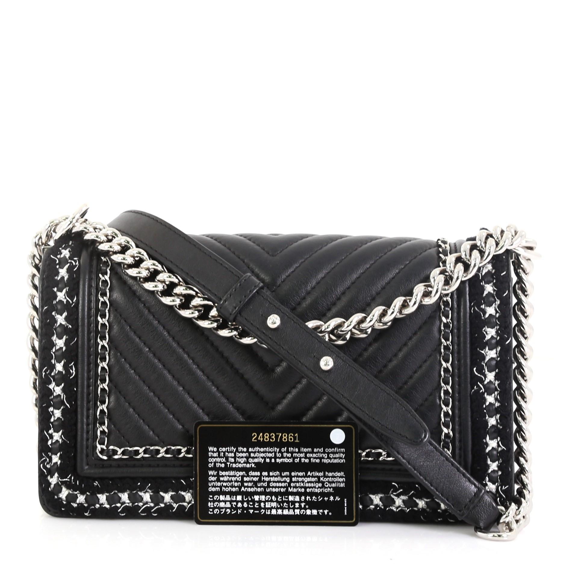 This Chanel Jacket Boy Flap Bag Chevron Calfskin with Tweed Old Medium, crafted in black chevron leather, features chain link strap with leather pad and silver-tone hardware. Its Boy push-lock closure opens to a black fabric interior with slip