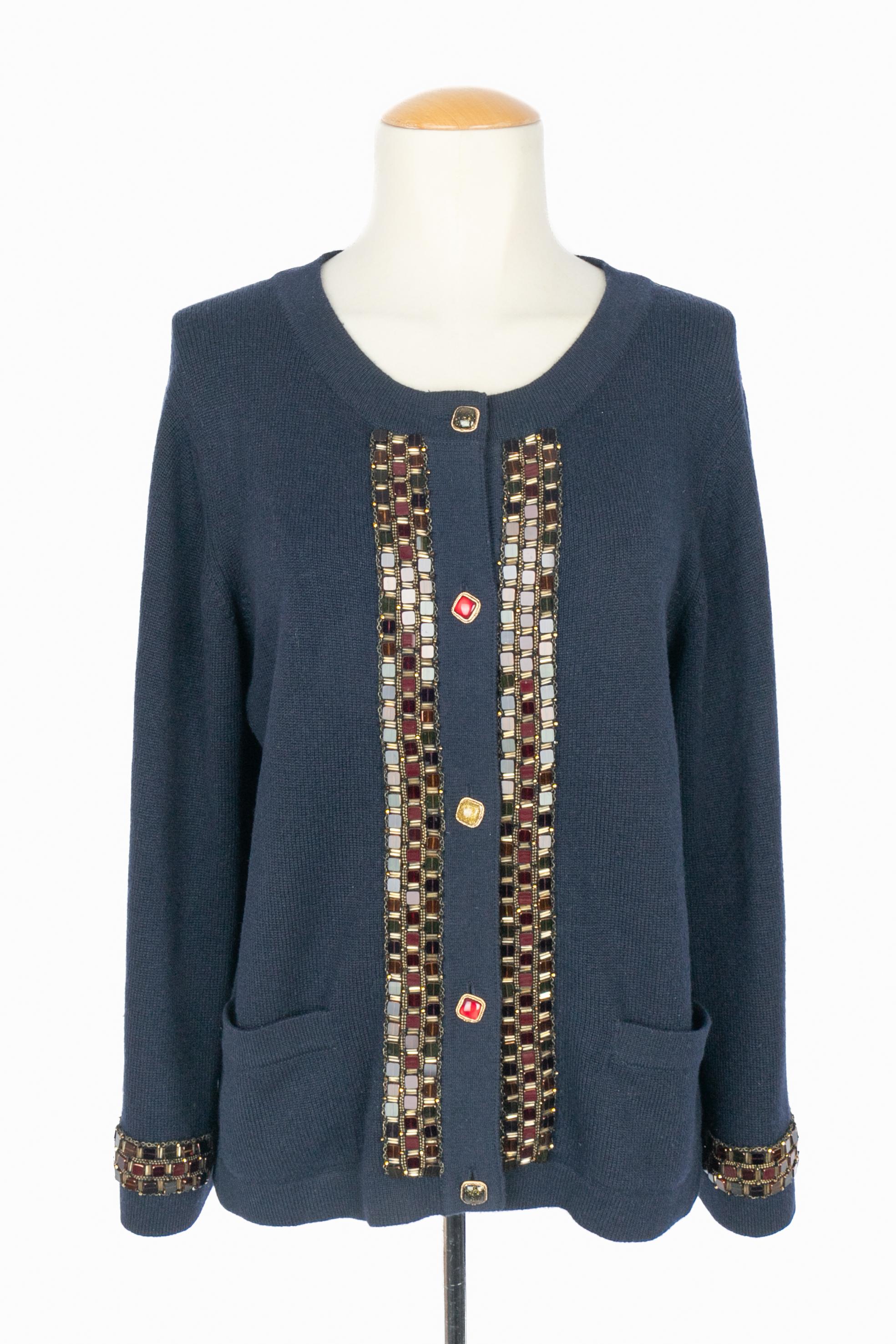 CHANEL - (Made in United Kingdom) Navy-blue cashmere cardigan jacket embroidered with tiny chains, pearls, and sequins. Golden metal buttons with resin. Size 42FR indicated. 2011 Pre-Fall Paris-Byzance Collection under the artistic direction of Karl