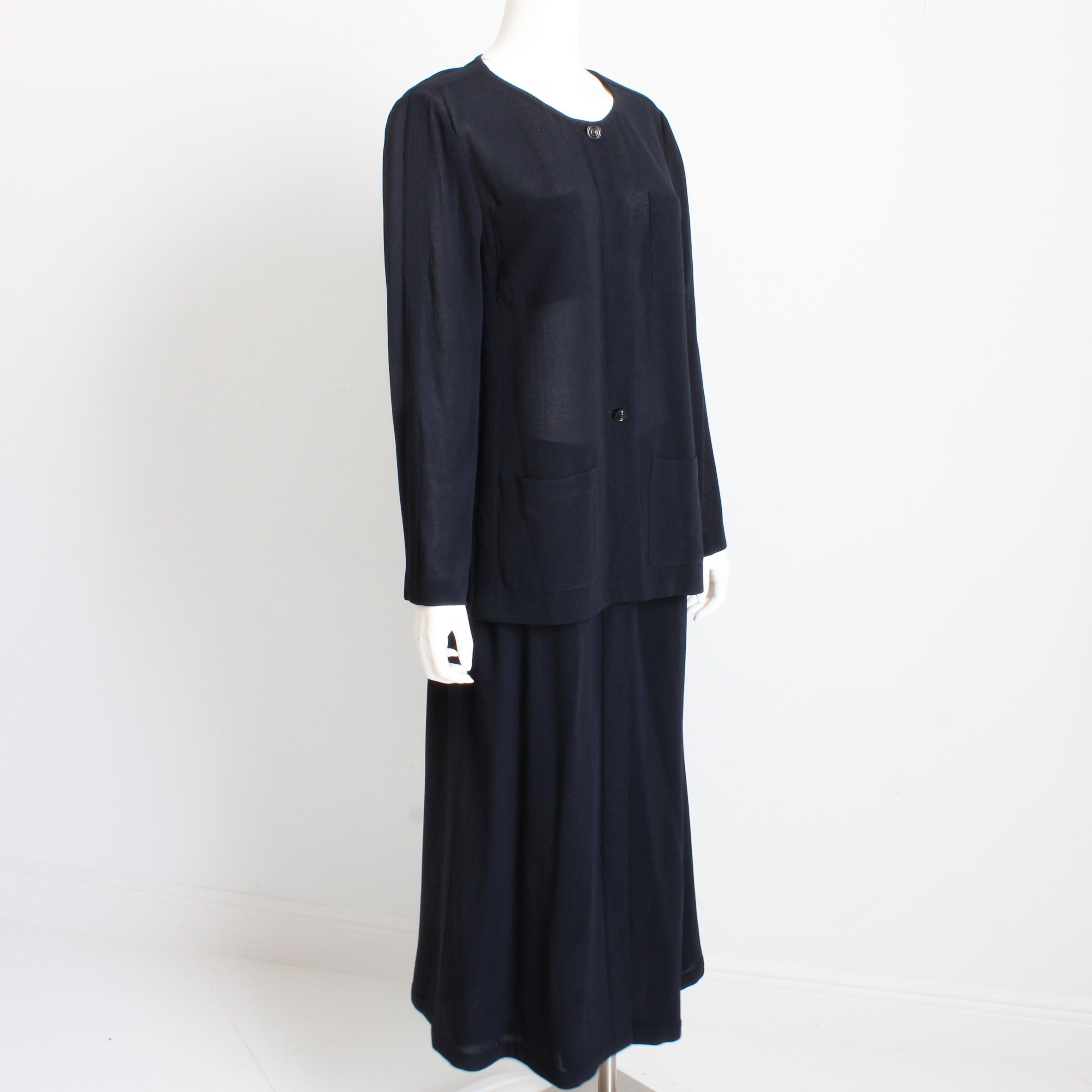 Preowned, vintage Chanel jacket and skirt suit from the 99P collection.  Made from an incredibly light and sheer navy wool crepe, the jacket features a collar button with CCs, and several hidden buttons, front pockets and a delicate silver chain