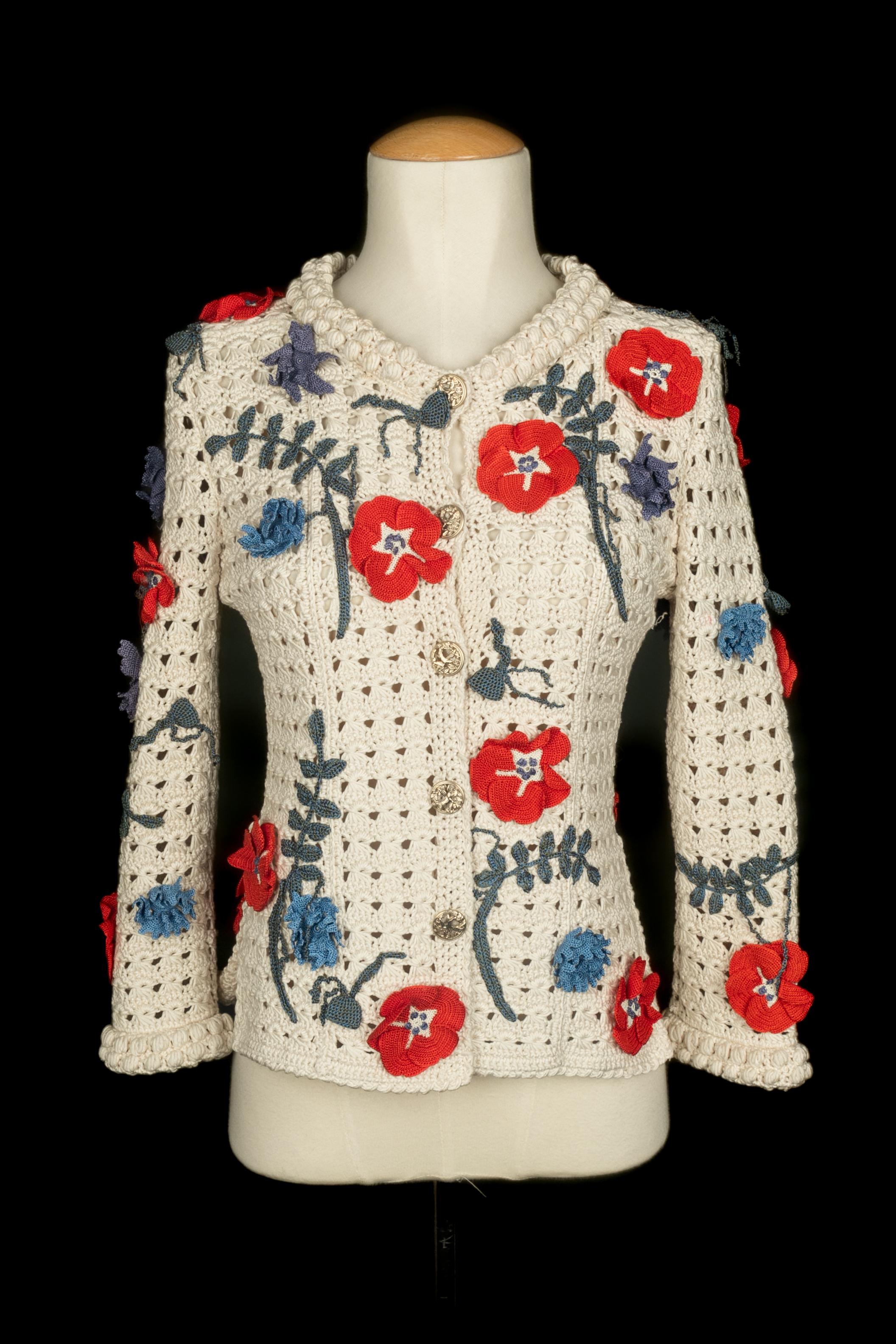 Chanel - (Made in Italy) Giacca bianca all'uncinetto con intarsi di fiori all'uncinetto nei toni del rosso e del blu. Taglia 34FR indicata. Collezione primavera-estate 2010 sotto la direzione artistica di Karl Lagerfeld.

Condizioni:
Ottime
