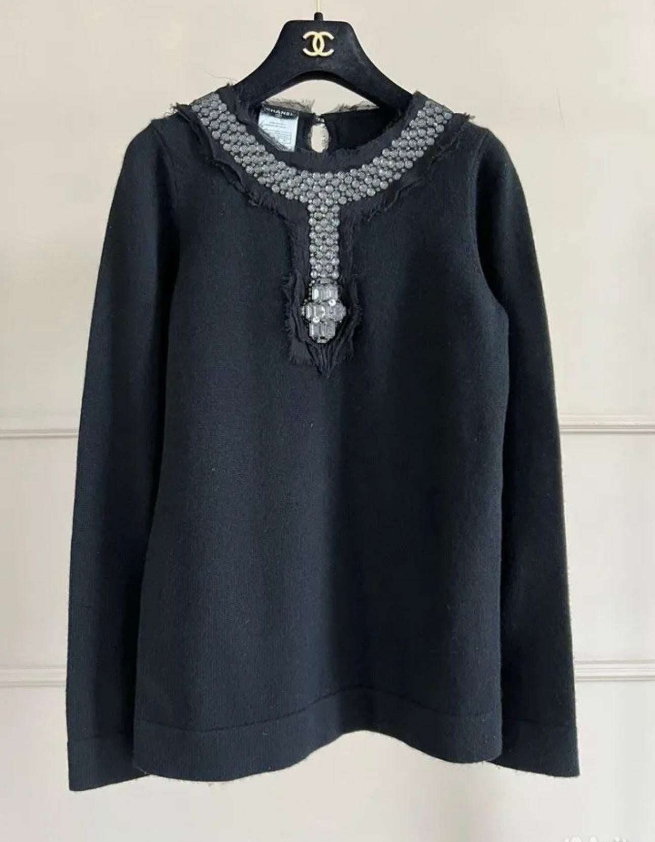 Rare, collectible piece!
Stunning Chanel black cashmere jumper with jewel adornment along the neckline.
- CC logo button at back
Size mark 40 FR. Pristine condition.