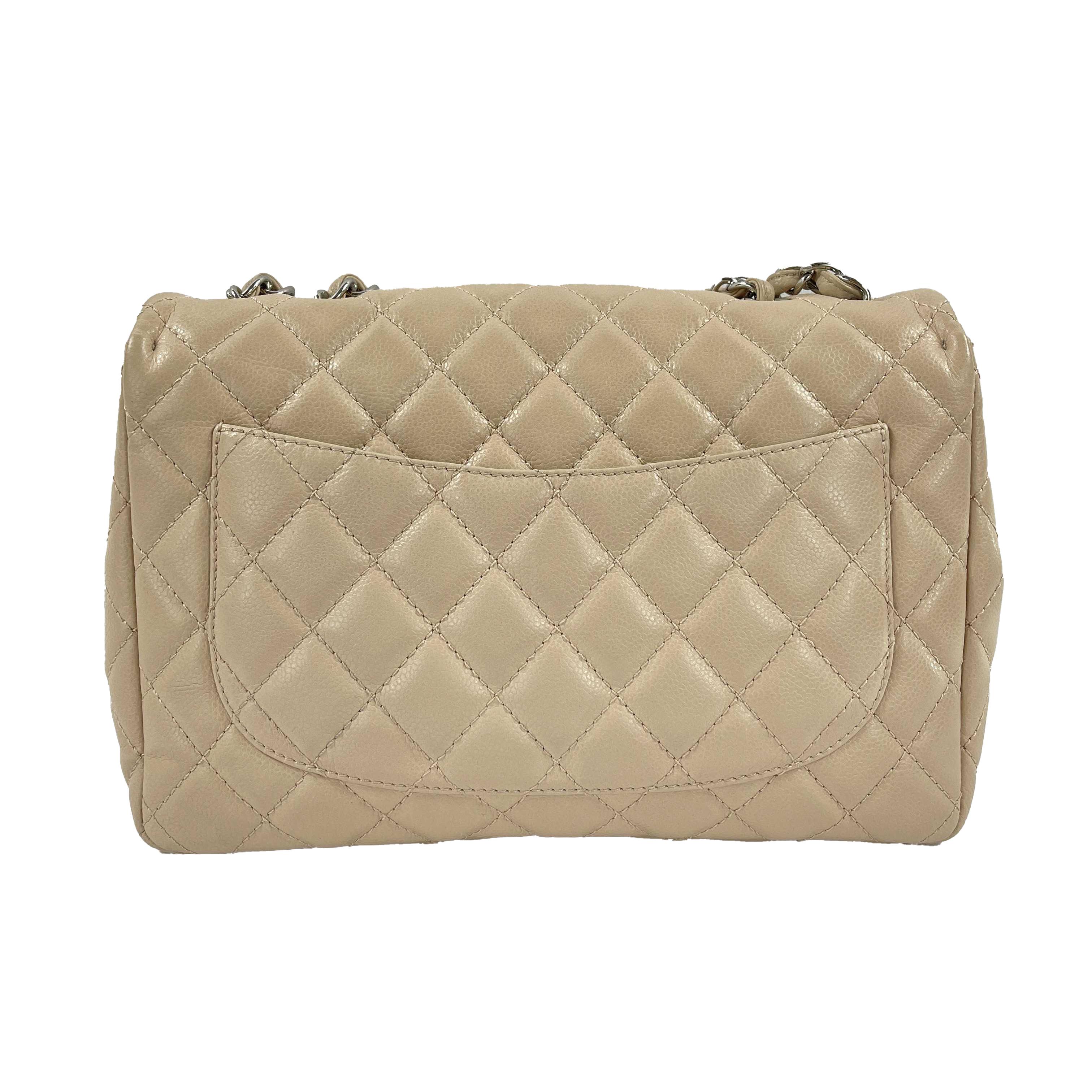 From the 2008 collection.
This classic Chanel flap handbag is crafted with beige quilted lambskin leather and silver-toned hardware.
The flap opens using an interlocking CC turn-lock to one compartment lined in a smooth beige leather with a slip