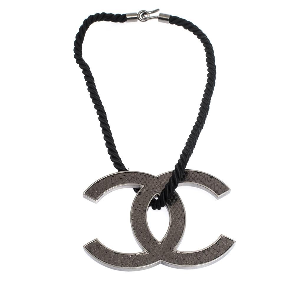 This simple and sophisticated design by Chanel is a must have in your jewelry box. This necklace is crafted from silver-tone metal and features a reversible CC pendant that is detailed with exotic snakeskin on one side and carries a matte finish on