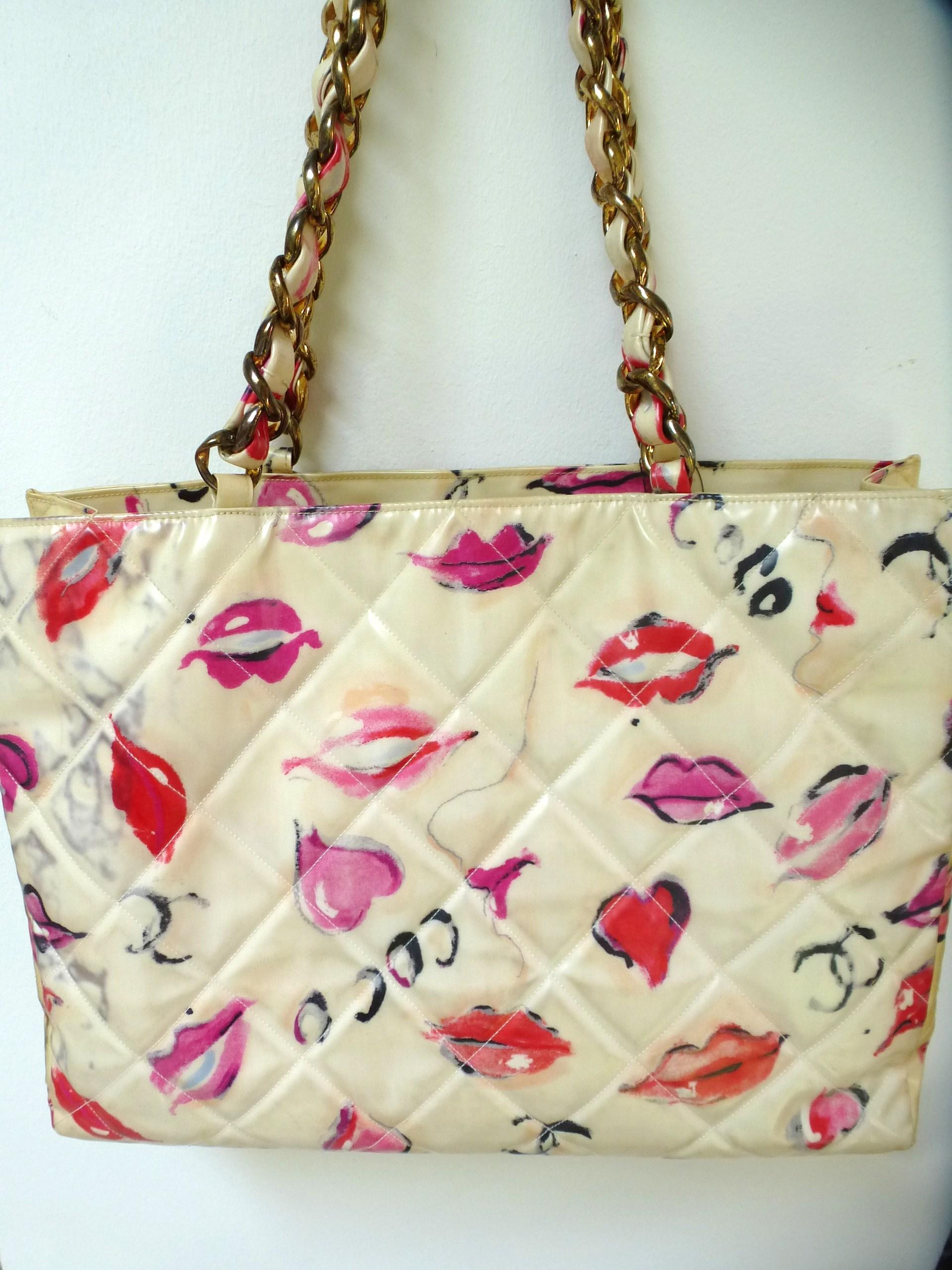 Chanel Jumbo Nylon Shopper Tot bag with lips, hearts Coco and CC's graffiti all over the bag. The front is quilted with large CC. The inside of the bag is filled with a light-colored rep, has 2 compartments on the side, one with a zip. ID card with