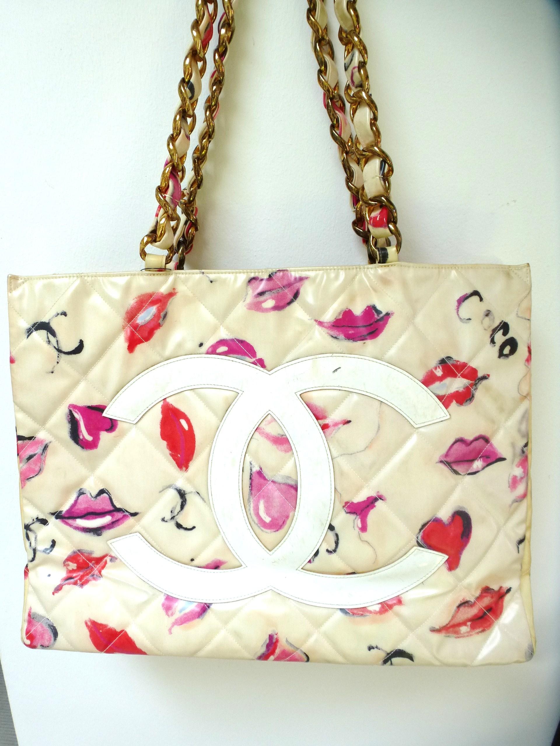 Chanel Jumbo Nylon Shopper Tot bag with lips, hearts Coco and CC's graffiti all over the bag. The front is quilted with large CC. The inside of the bag is filled with a light-colored rep, has 2 compartments on the side, one with a zip. ID card with