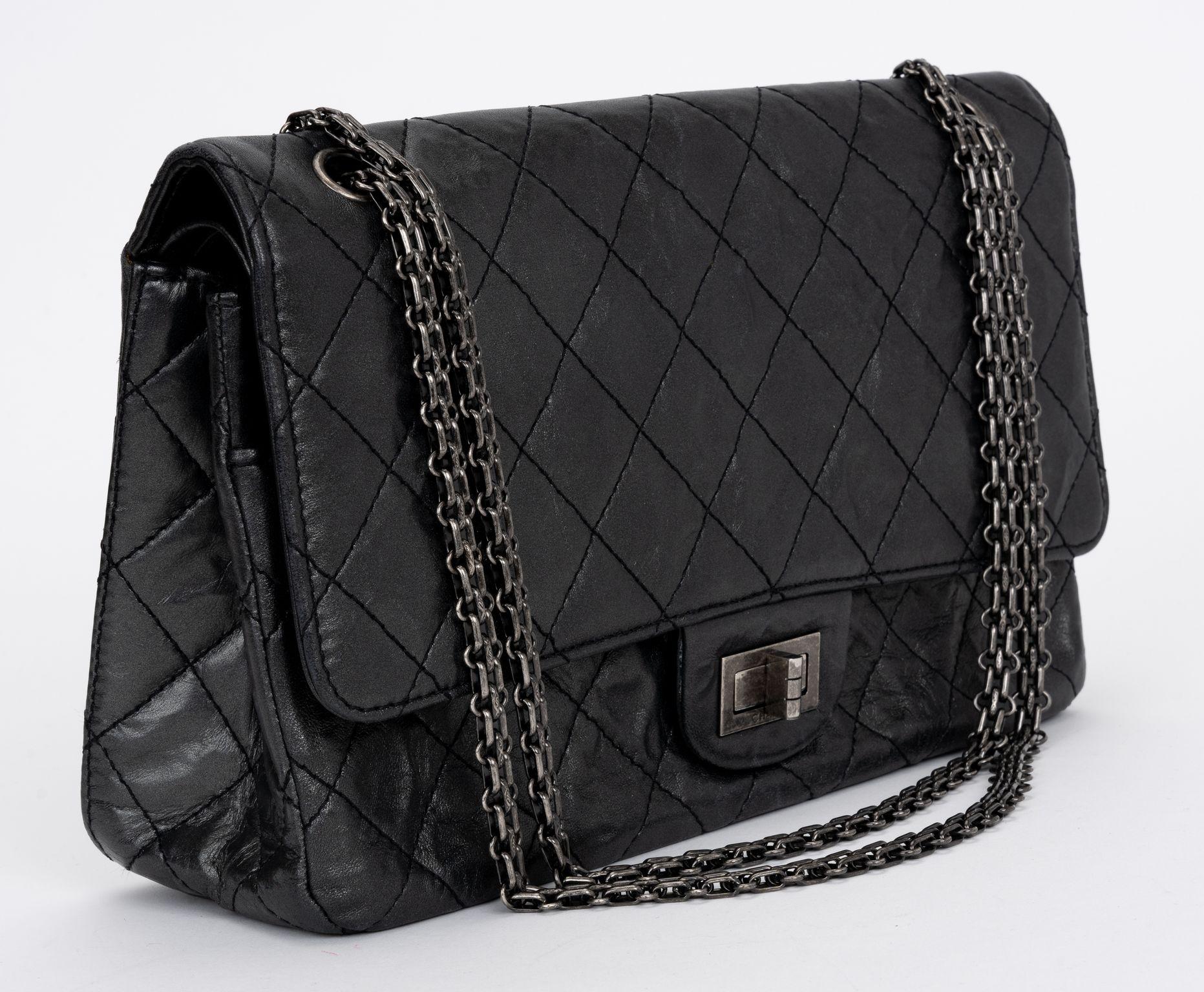 The Chanel Medium 226 Black aged Calfskin with Ruthenium hardware, tonal stitching, turn lock closure, half moon pocket and reissue chain. Shoulder drop 10