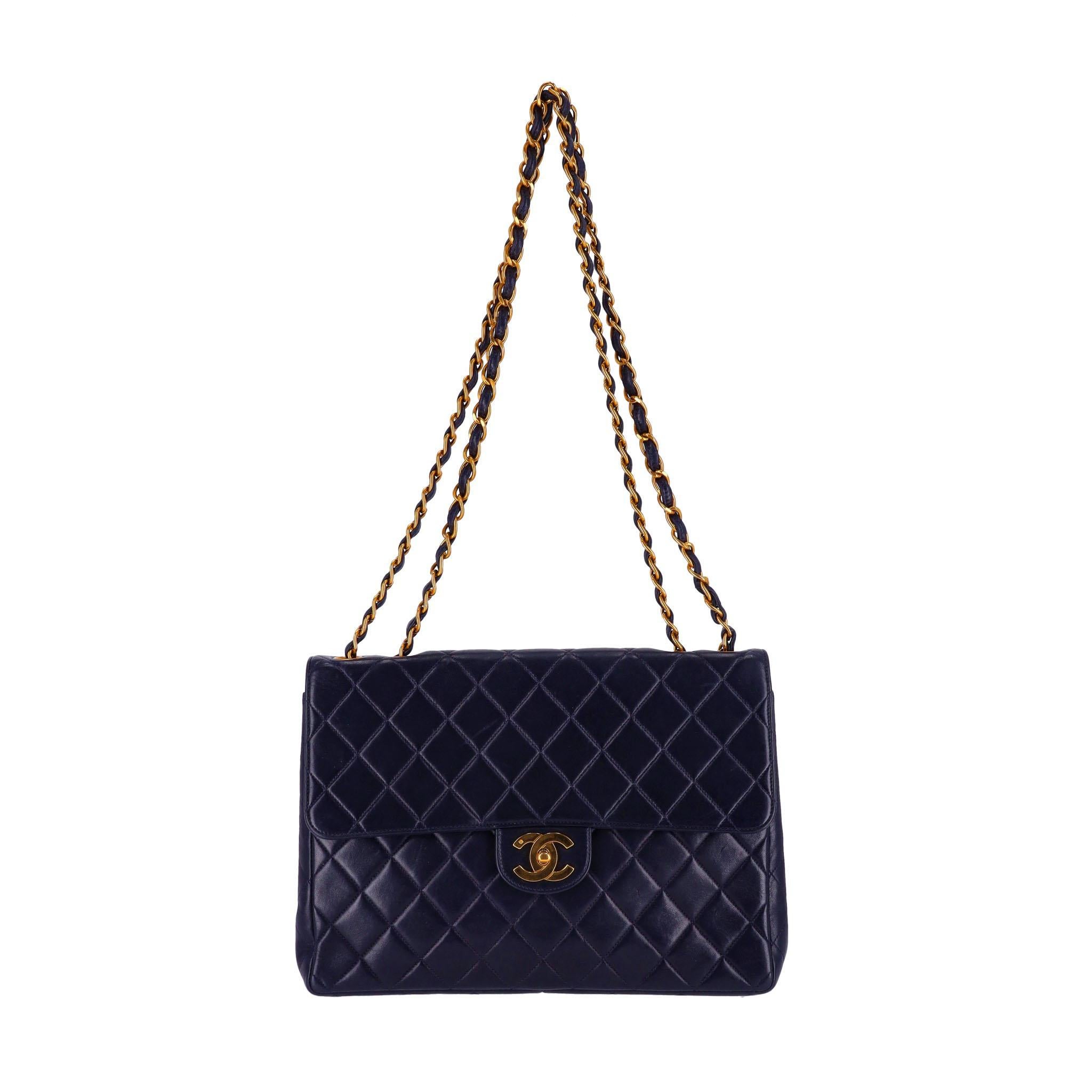 Chanel Jumbo Vintage Lambskin Leather Quilted Timeless Bag

Navy smooth leather, single flap edition with quilted diamond stitching, 24k gold 'CC' twist lock closure and leather/gold entwined chain shoulder strap. Strap can be worn longer on the