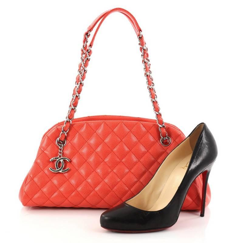 This authentic Chanel Just Mademoiselle Handbag Quilted Caviar Medium showcases a sleek style that complements any look. Crafted from beautiful coral caviar leather in Chanel's iconic diamond stitch pattern, this bag features dual woven-in leather