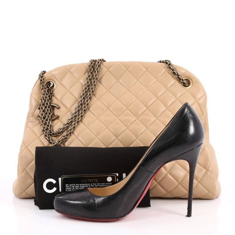 This authentic Chanel Just Mademoiselle Handbag Quilted Lambskin Large showcases a sleek style that complements any look. Crafted from beautiful beige lambskin leather in Chanel's iconic diamond stitch pattern, this bag features Chanel Reissue Chain