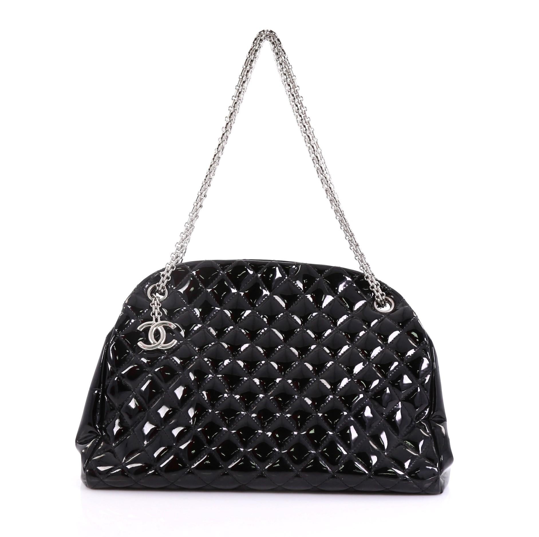 This Chanel Just Mademoiselle Handbag Quilted Patent Large, crafted from black quilted patent leather, features reissue chain straps, and silver-tone hardware. It opens to a burgundy fabric interior with two side compartments and a middle zip