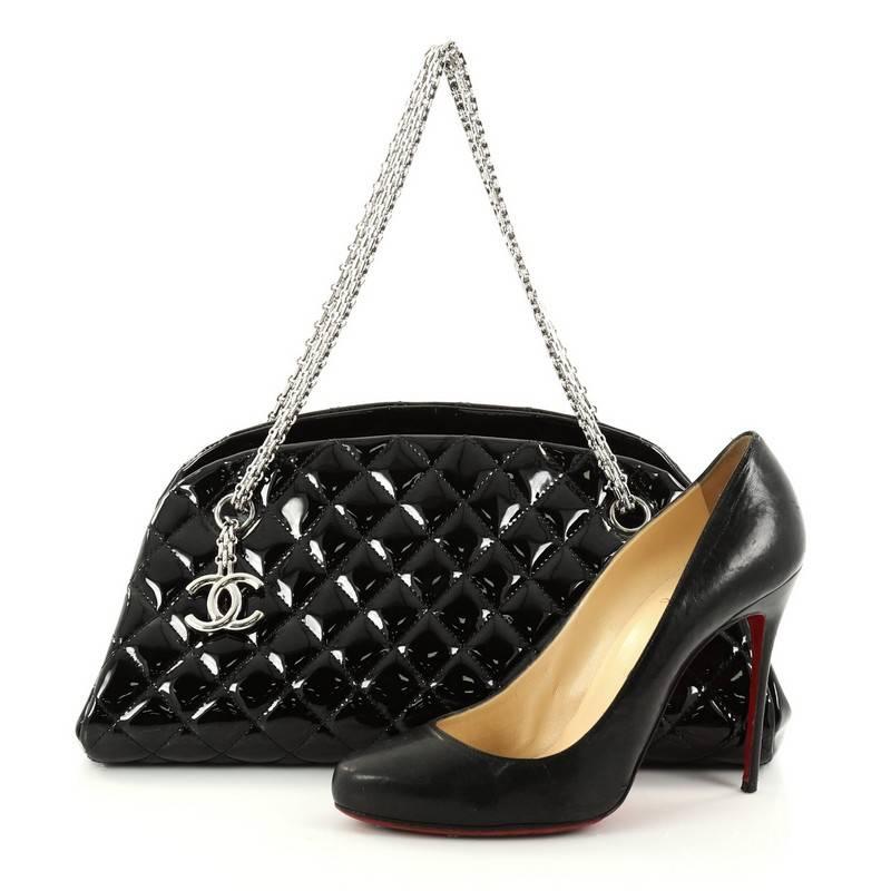 This authentic Chanel Just Mademoiselle Handbag Quilted Patent Medium showcases a sleek style that complements any look. Crafted from black patent leather in Chanel's iconic diamond quilt pattern, this bag features mademoiselle chain straps, a