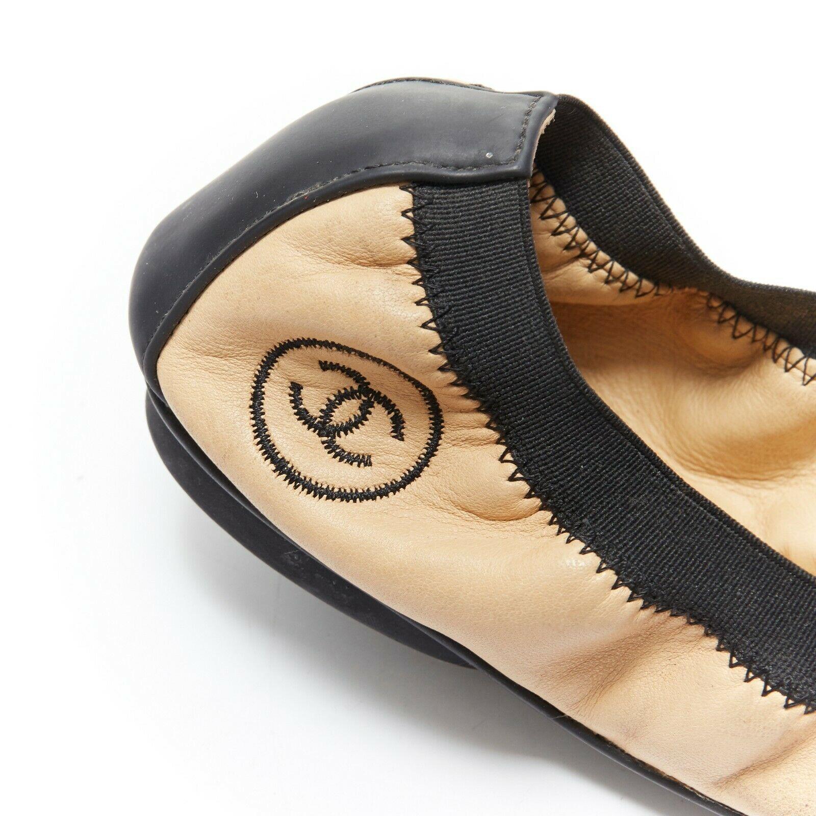 CHANEL KARL LAGERFELD nude beige black elastic band classic ballet flats EU37.5 
Reference: EACN/A00088 
Brand: Chanel 
Designer: Karl Lagerfeld 
Material: leather 
Color: Beige 
Extra Detail: Ballet flats. Round Toe cap. Elastic band trims.