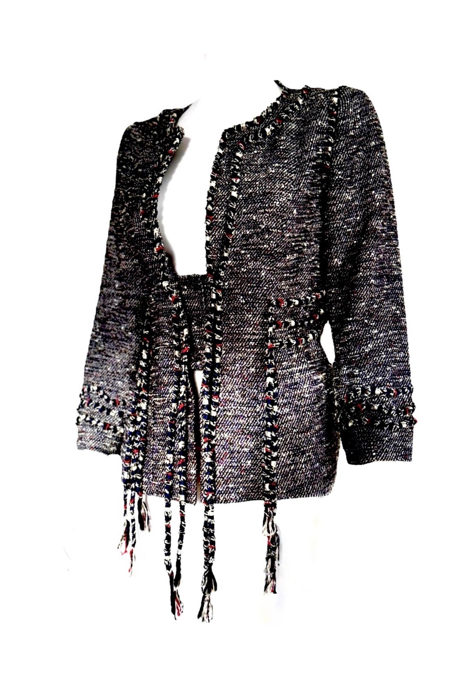 A stunning statement of Chanel craftsmanship from the Spring 2010 collection by Karl Lagerfeld.
Multicolored tweed jacket featuring braided trims, woven fringe, and an interlocking CC camellia three-button front closure. Finished with a