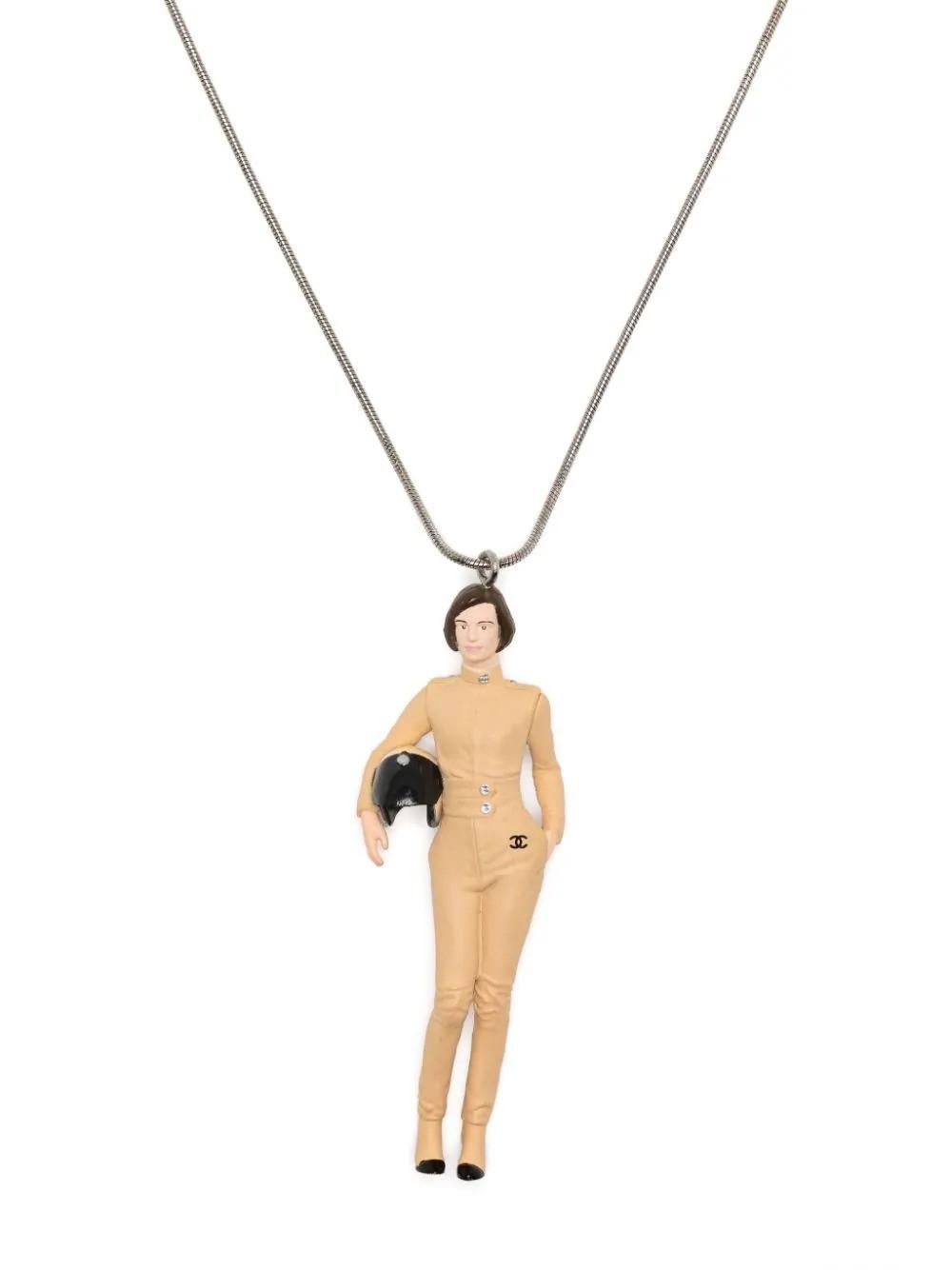 This beige necklace from Chanel features a stunning silver-plated design. With its bold and luxurious appearance, this necklace is the perfect addition to any outfit. The sleek beige colour adds sophistication and style, while the silver plating