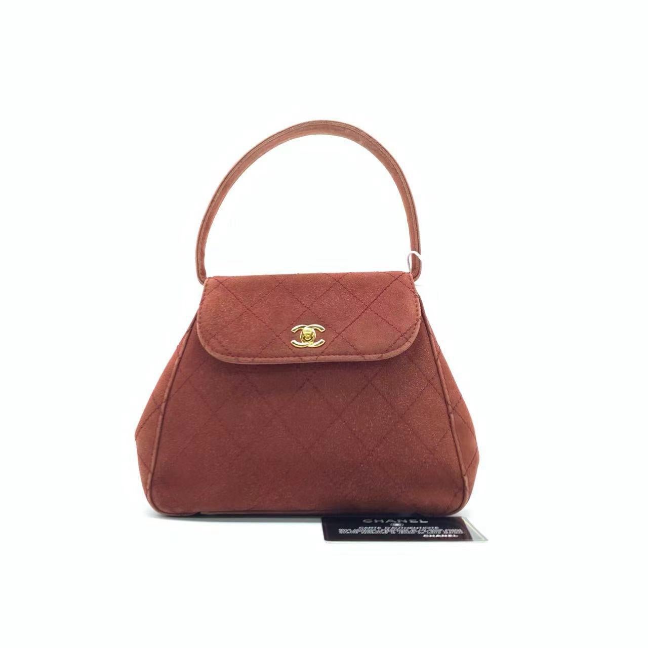 Chanel Kelly Mini 1997 -1999 Caramel Tan Suede Leather Top Handle Bag
These are professional photos of the actual bag.
  CONDITION: GOOD
  This authentic vintage Chanel bag is in very good condition with some signs of use throughout. There are some