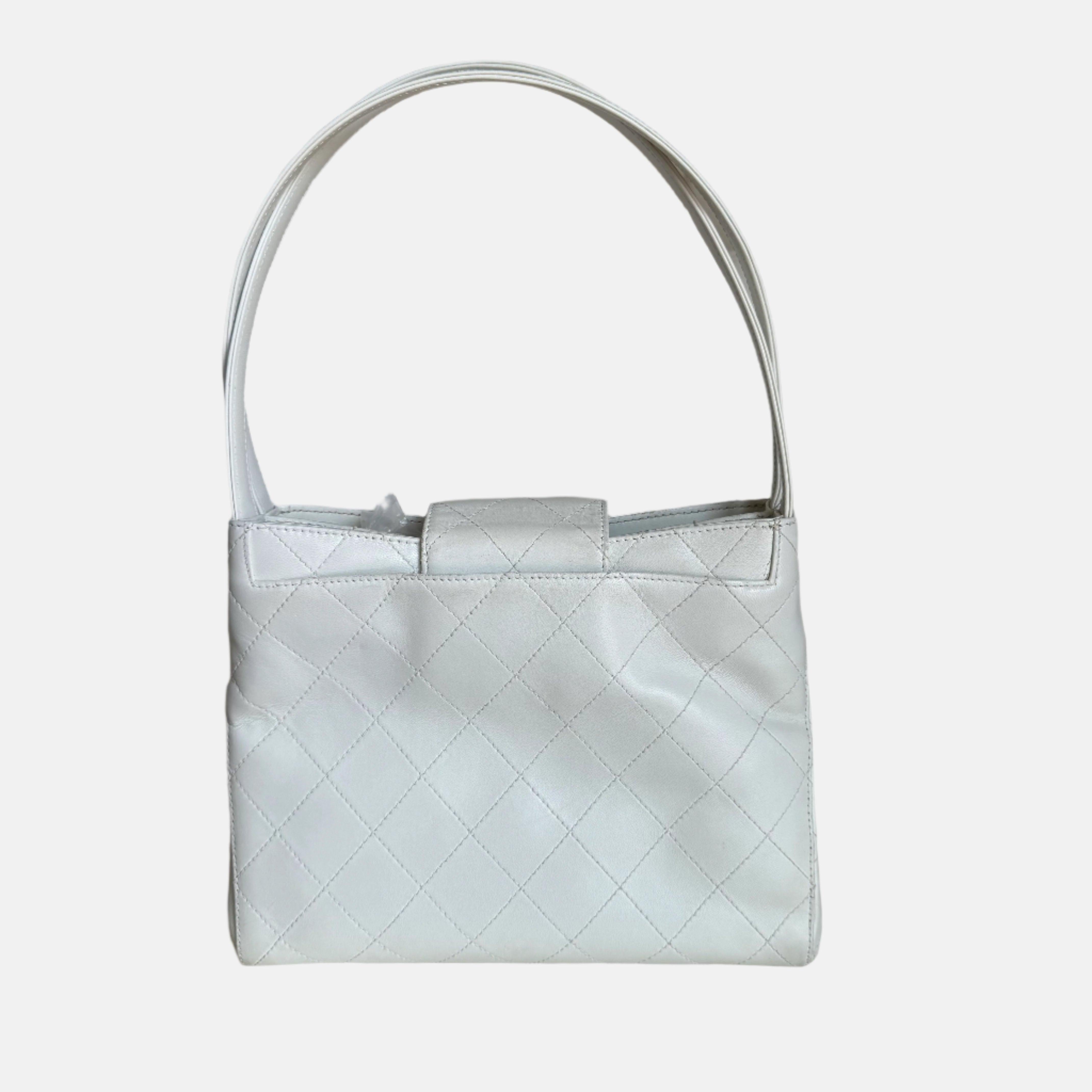 Chanel Kelly Top Handle Bag White Leather
 These are professional photos of the actual bag offered by Luxbags.
 CONDITION: Very good
 This authentic vintage Chanel bag is in very good condition with moderate signs of use throughout Rubbing on the