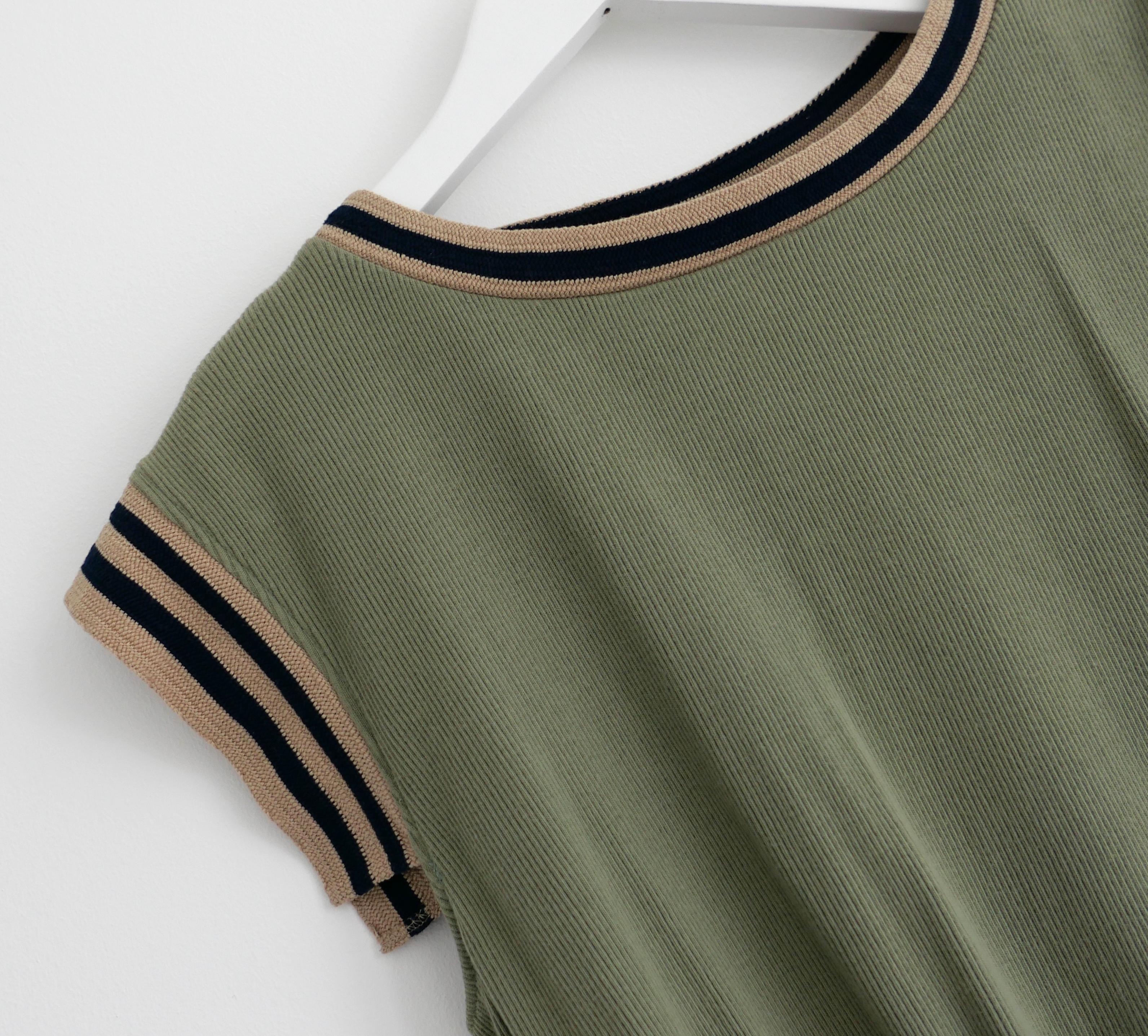 Chicest Chanel khaki knit top from the Cruise 2017 17C ‘Cuba’ collection. Look 37 on the runway. Unworn. Made from soft, stretchy vintage wash ribbed cotton jersey with black and beige striped trims. It has an elasticated waist,  cap sleeves and