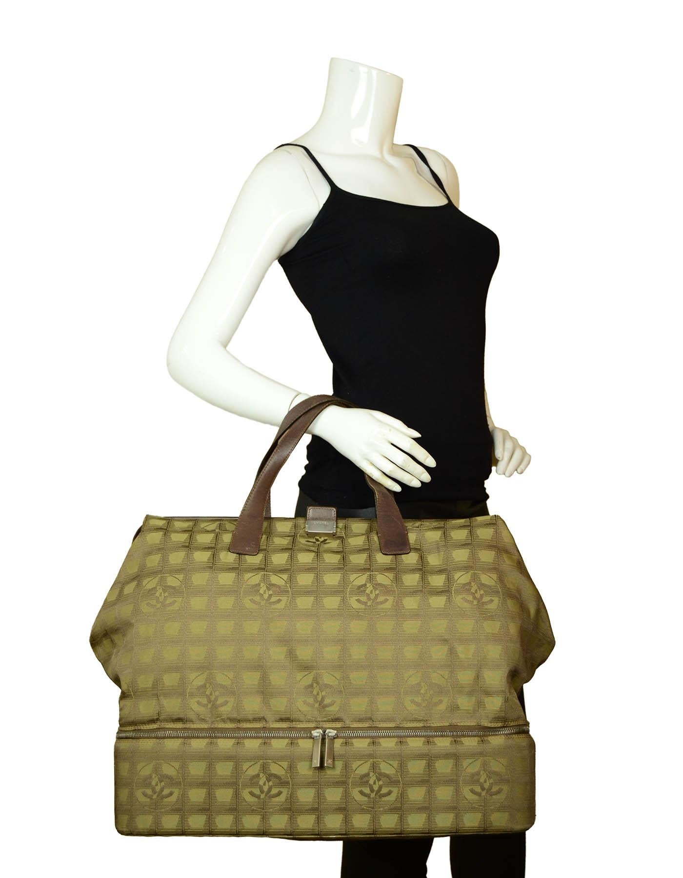 Chanel Khaki Travel Ligne Frame Bag.  

**Please note, this bag is a press sample and is stamped PRESSE inside the interior wall pocket**

Made In: Italy
Color: Khaki
Hardware: Silvertone
Materials: Canvas
Lining: Textile
Closure/Opening: